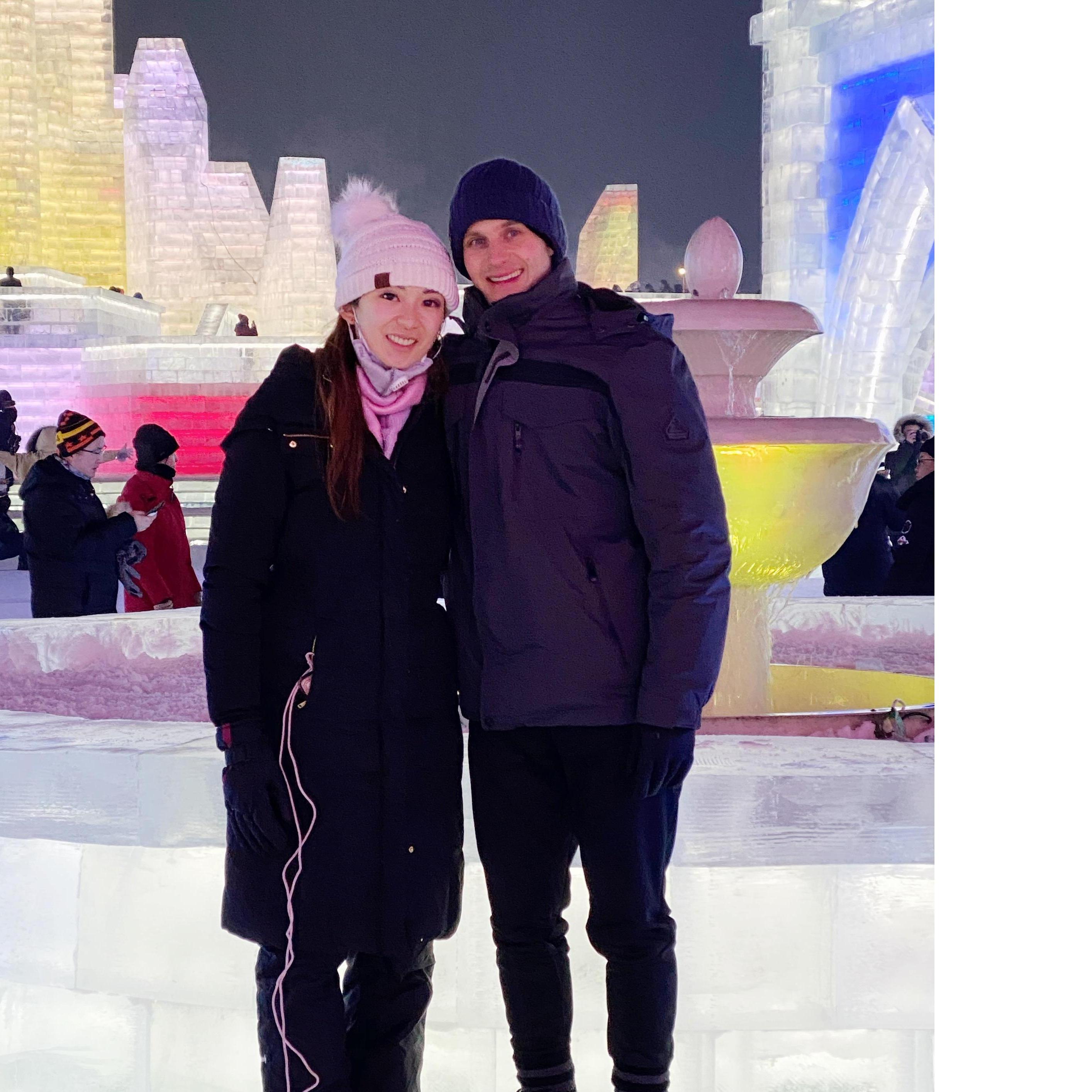 In Harbin in front of the beautiful man-made ice castles and snow sculptures.