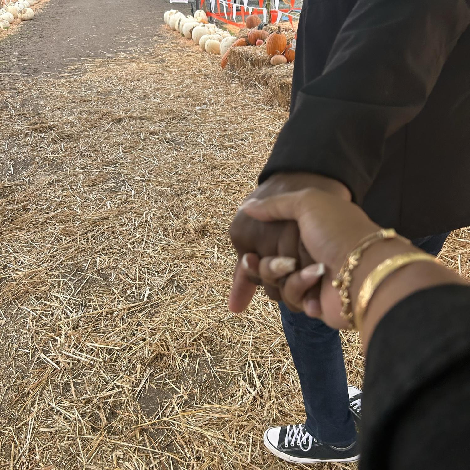 Strolling the pumpkin patch, hand in hand.
