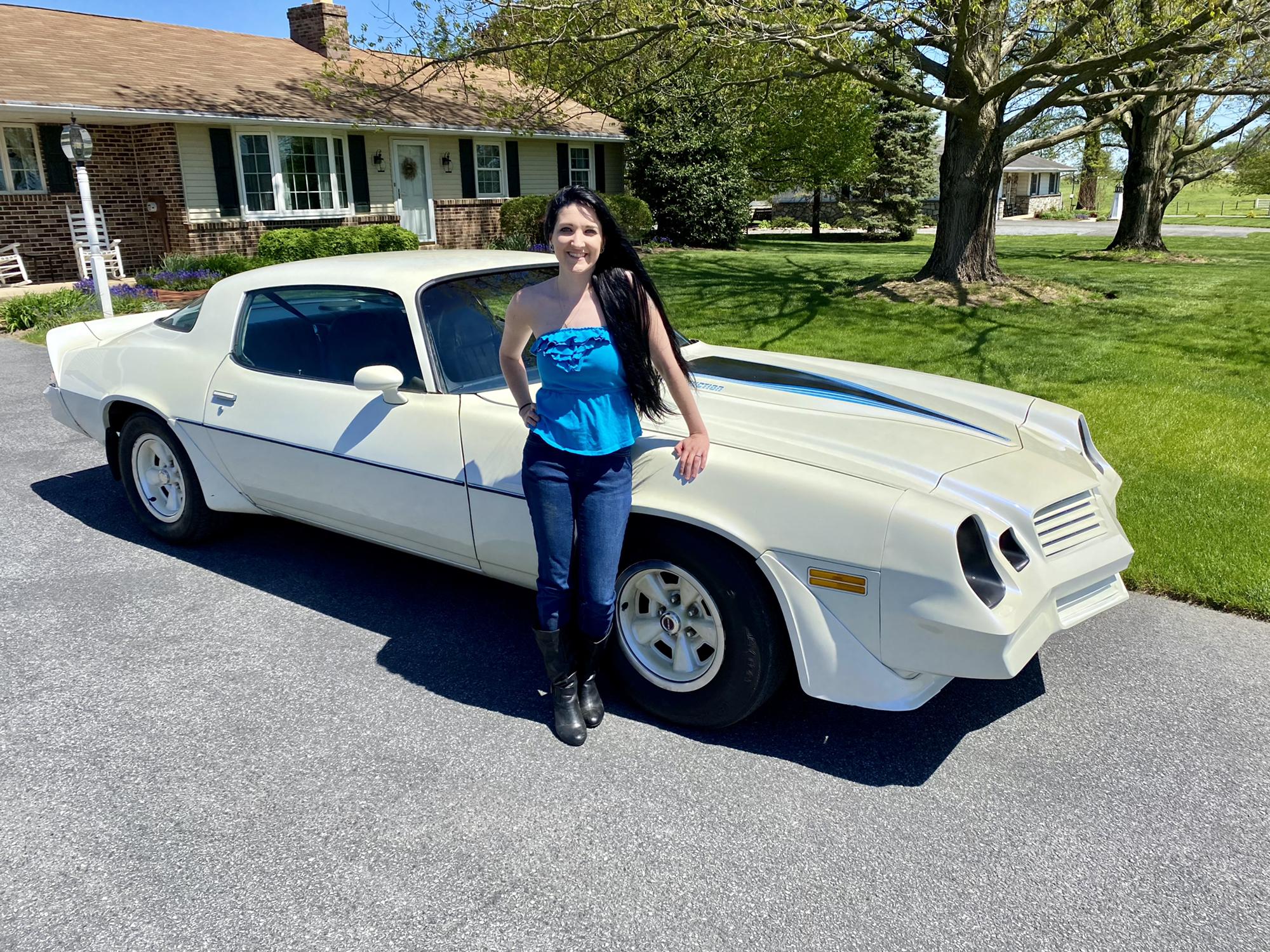 Allison with her dads Camaro, she prefers old cars and trucks