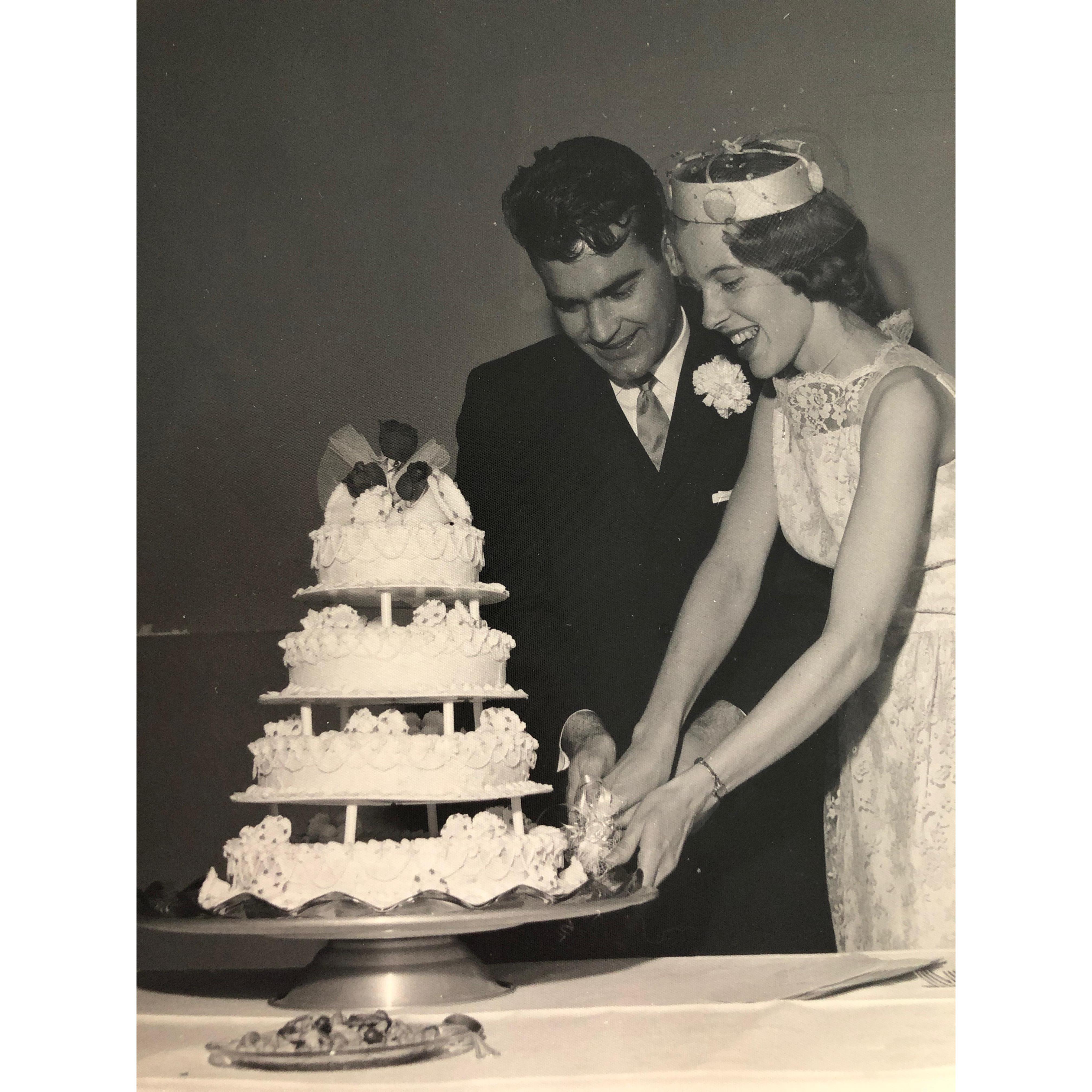 Elbert and Carol with their wedding-bell cake.
