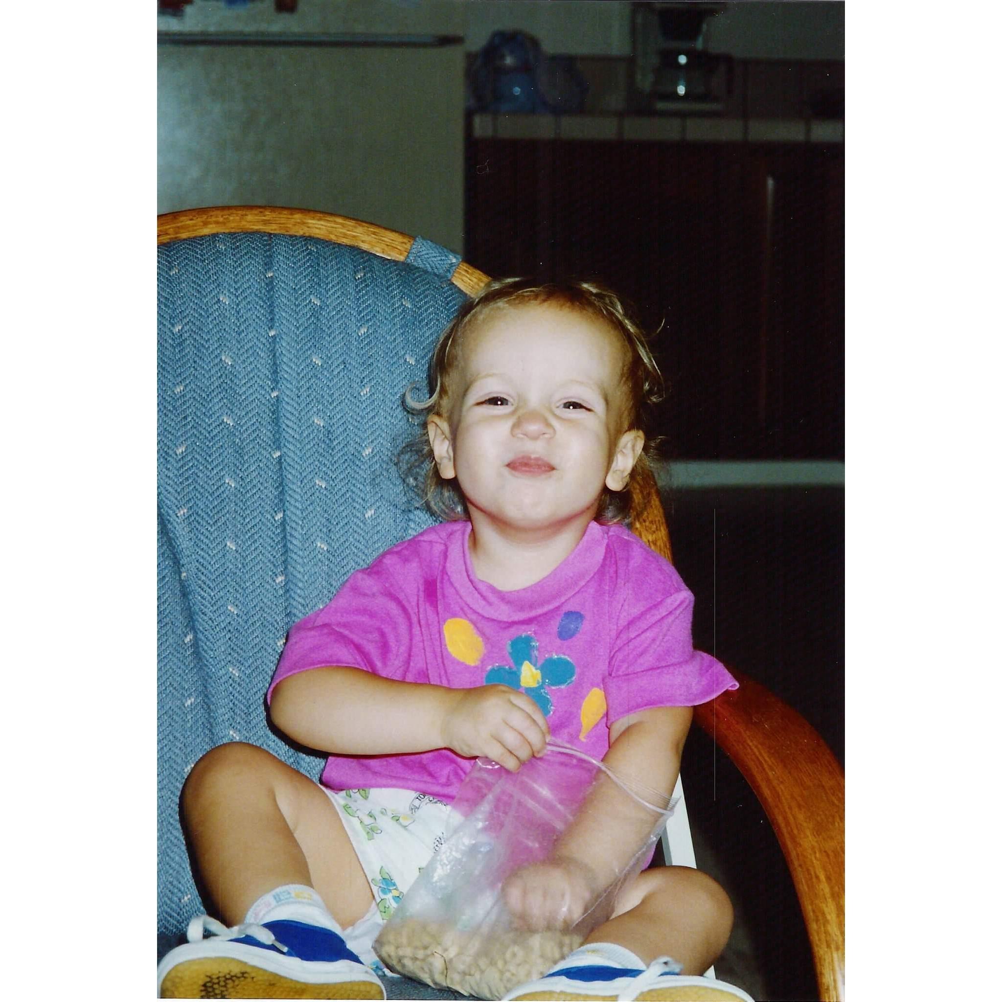 Sariah smiles and eats some Cherrios!