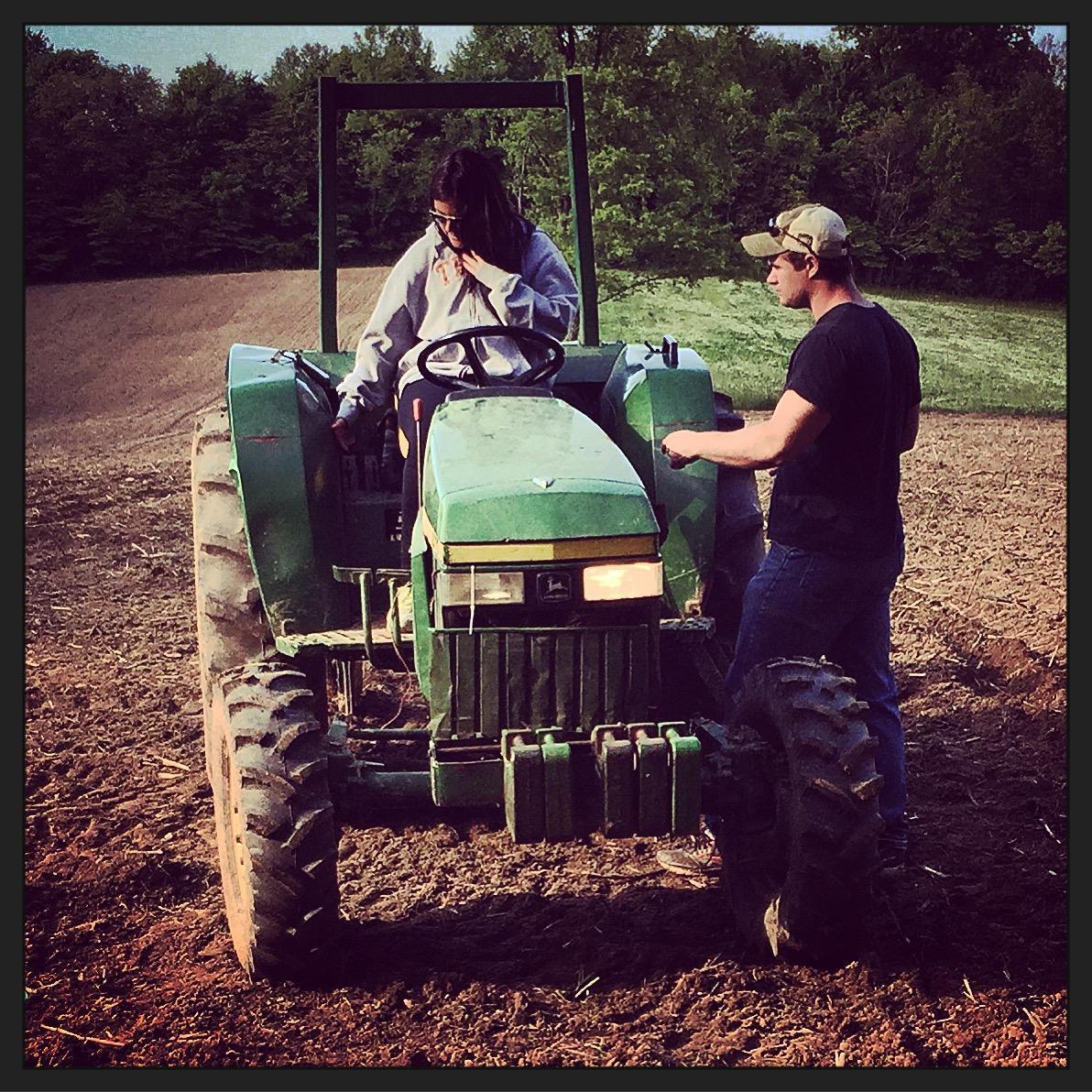 Teaching me how to drive the tractor.