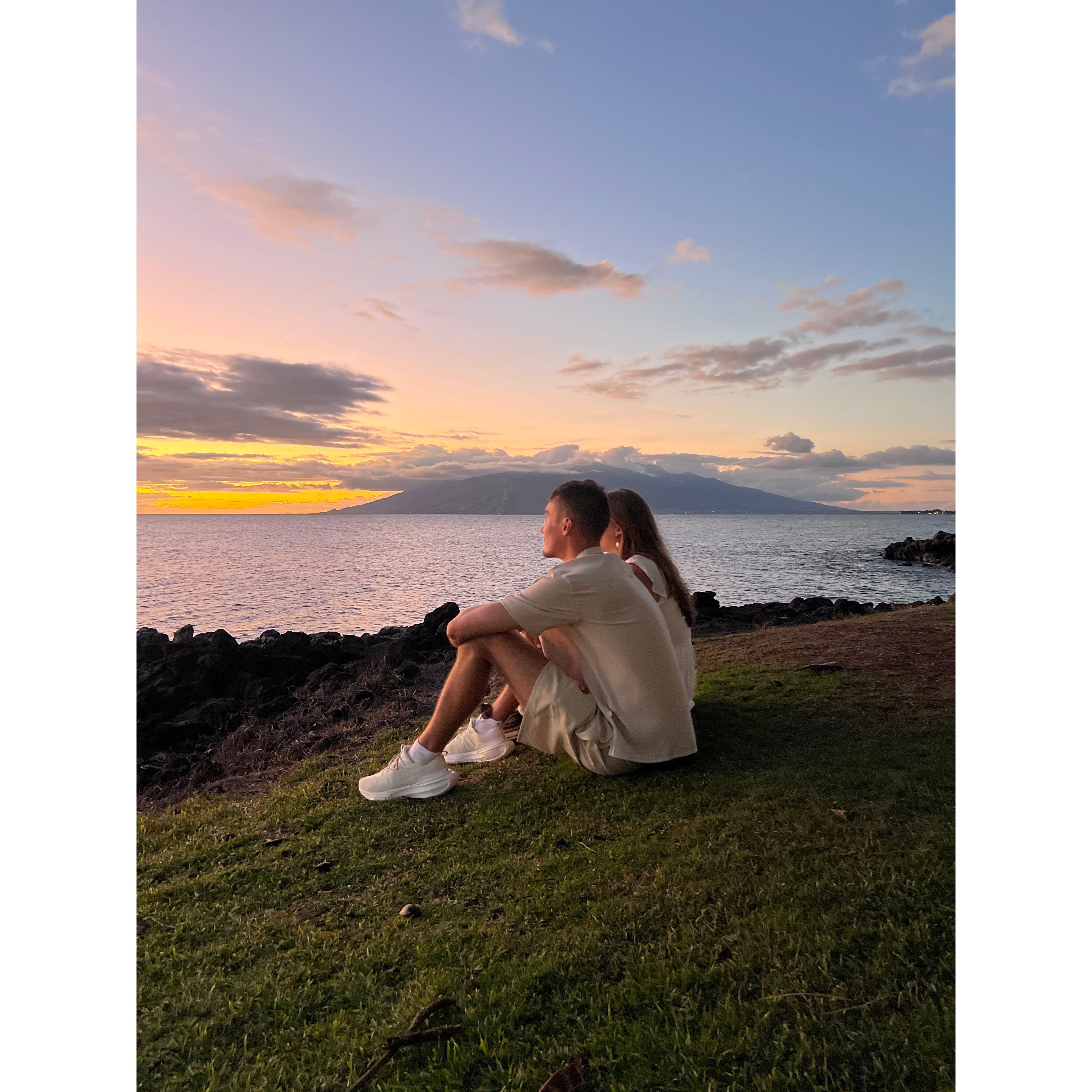 overlooking the ocean together watching the sunset in hawaii right after the proposal