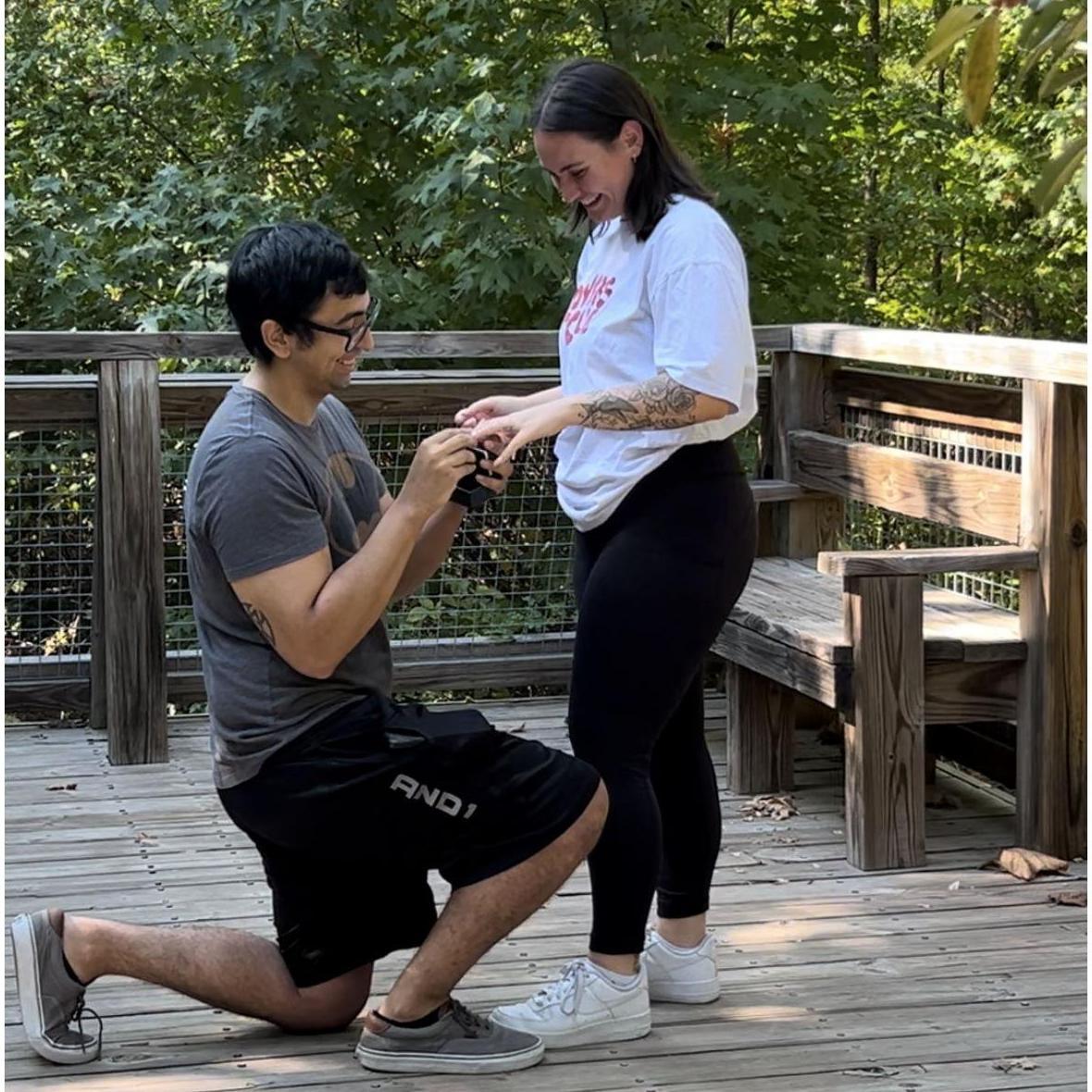 Tristan proposing to Jeni in a private and intimate setting in the woods.