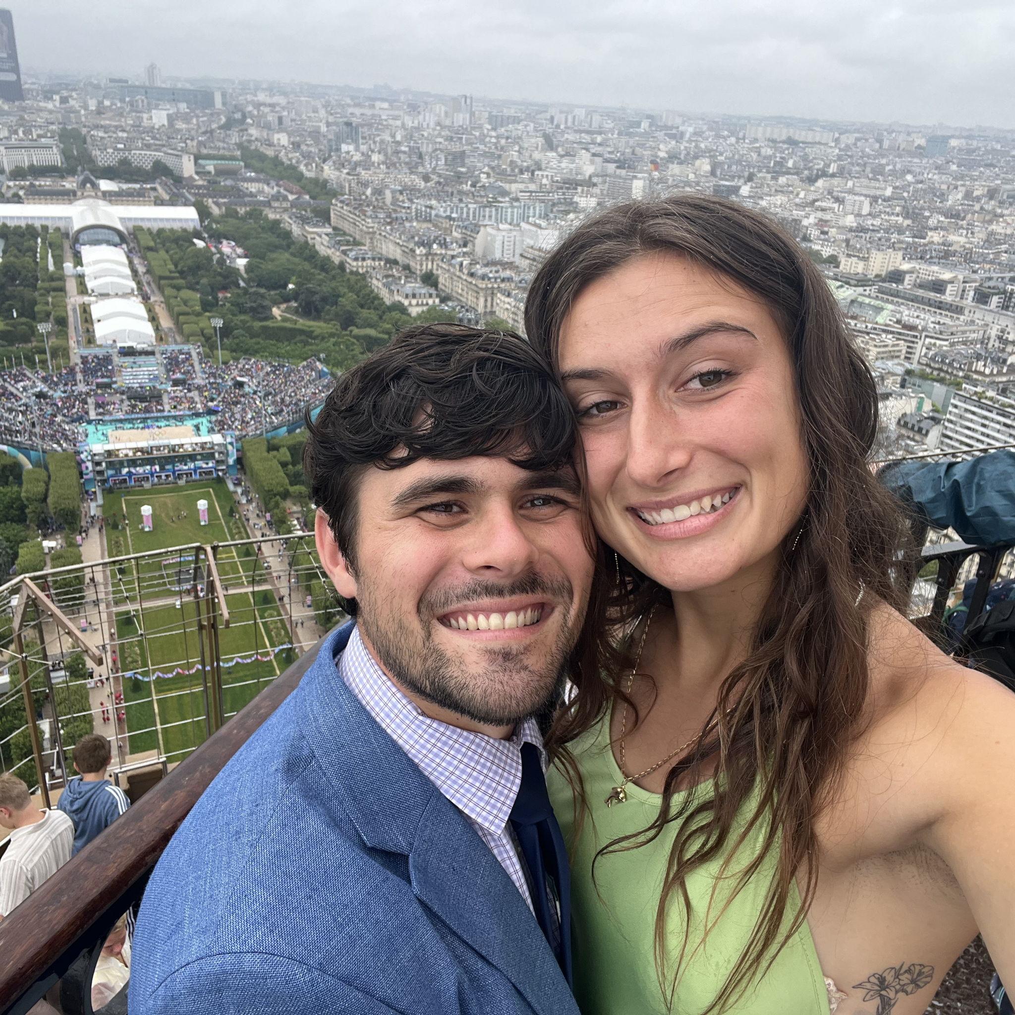 James and Charlotte on the Eiffel Tower, looking down at beach volley during the Olympic Games