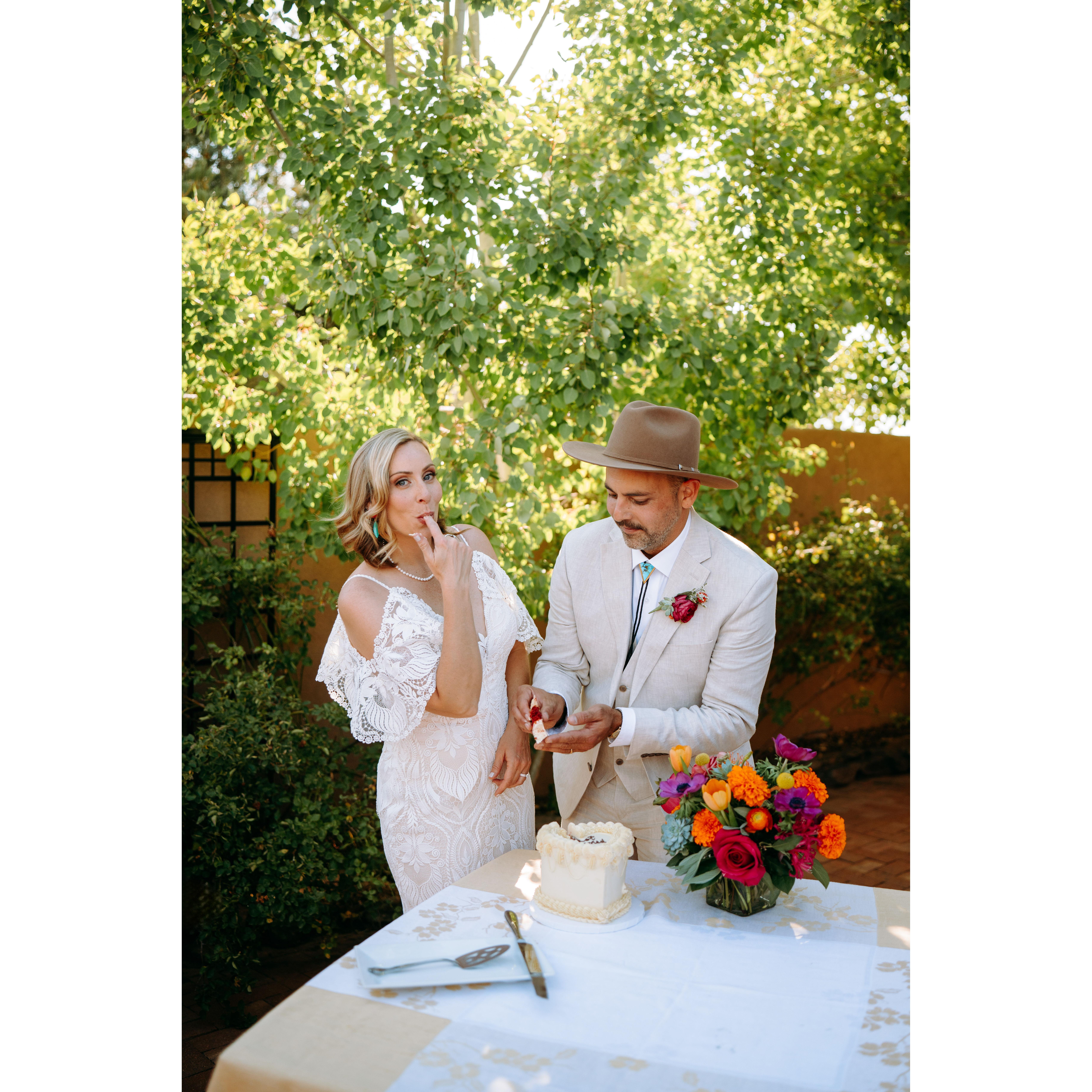 Jenn and Shae have fun cutting the wedding cake and serving it to each other