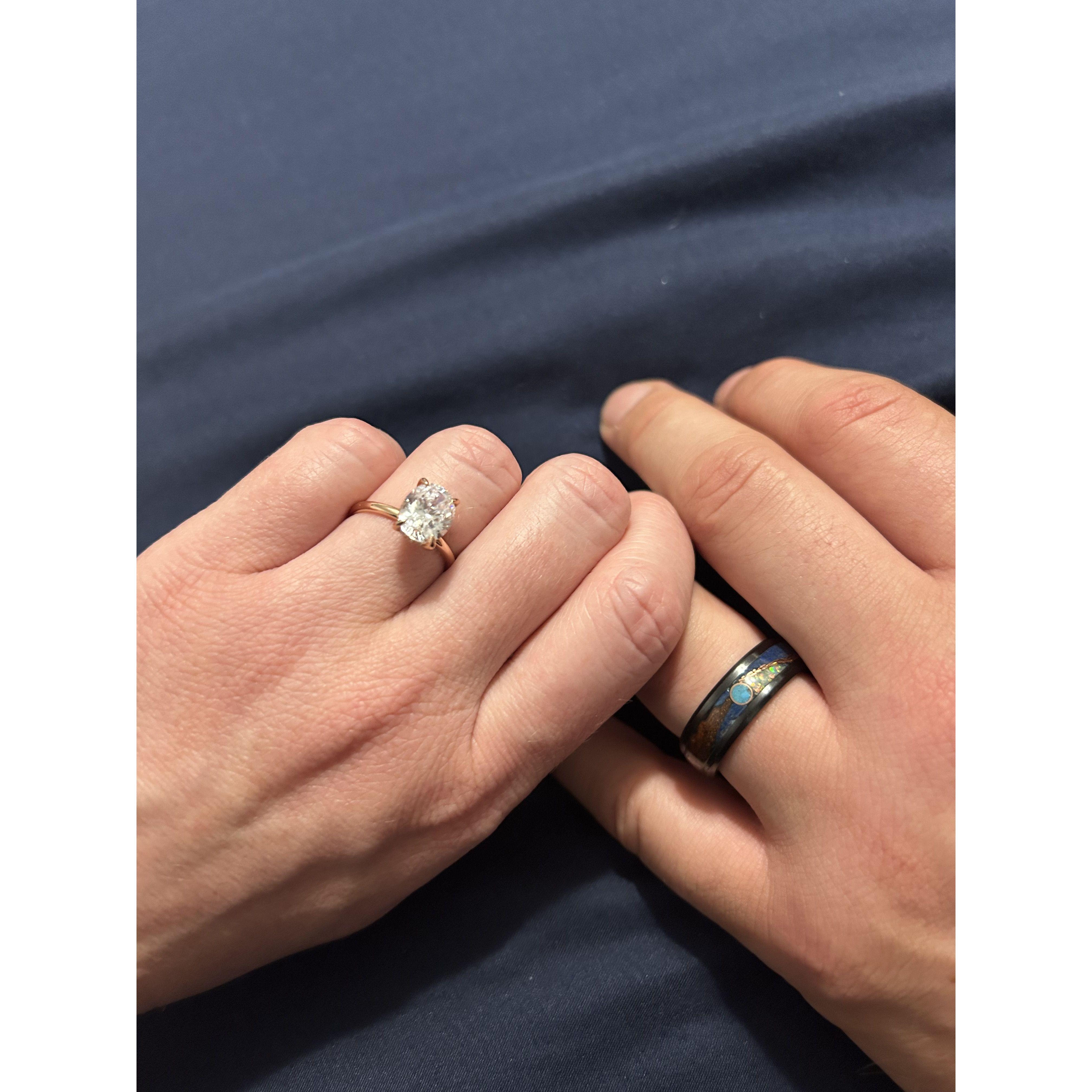 We gave each other engagement rings. Mine is a solataire, and Justin's is made by a local artist using different stones to make a Tennessee landscape.