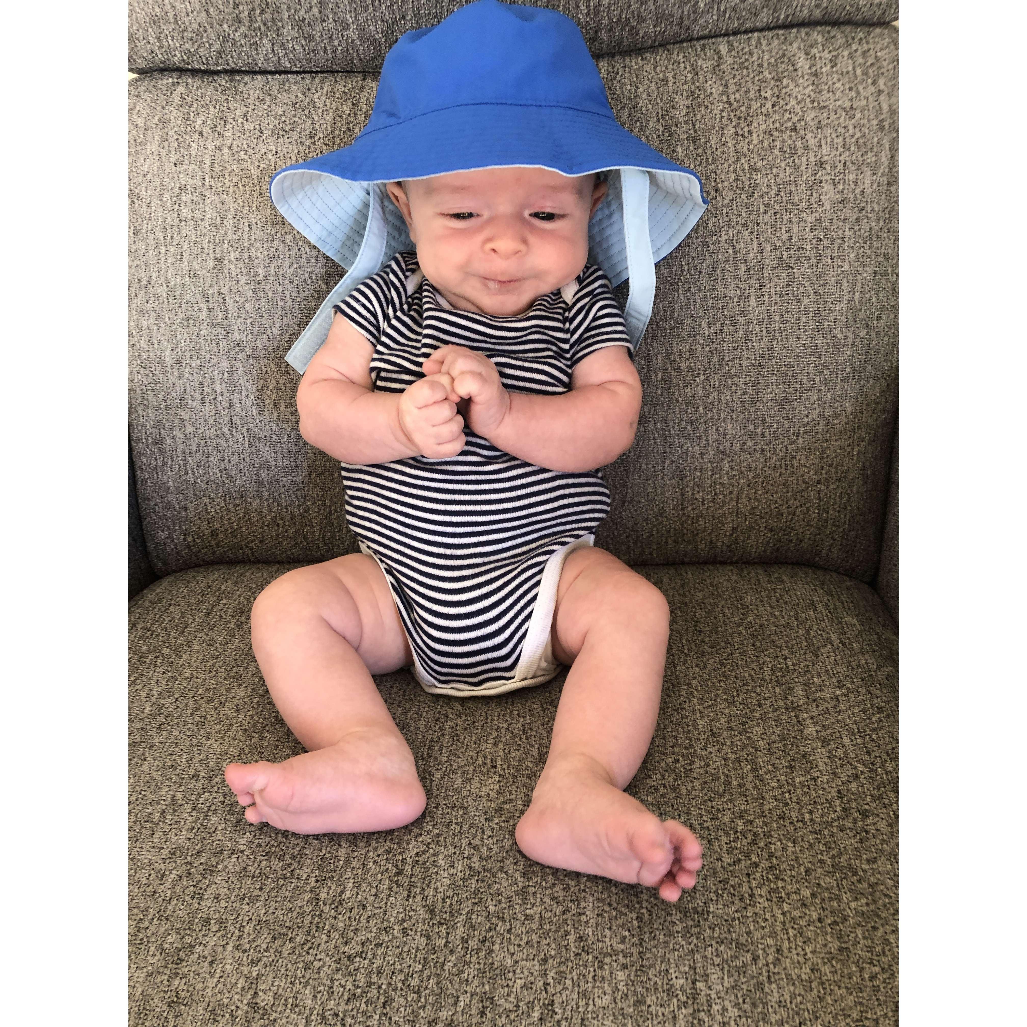 2 months old trying on his vacation hat