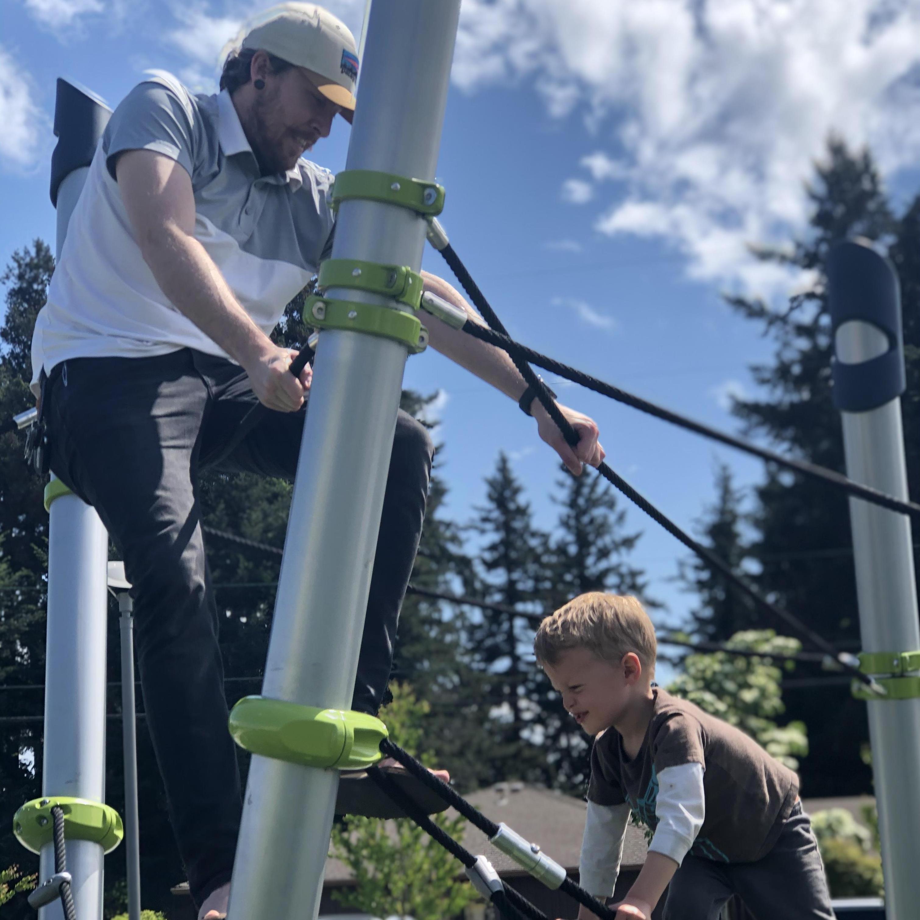 Aragon and Emily's little brother Ansel seeing who can climb higher at the local park.