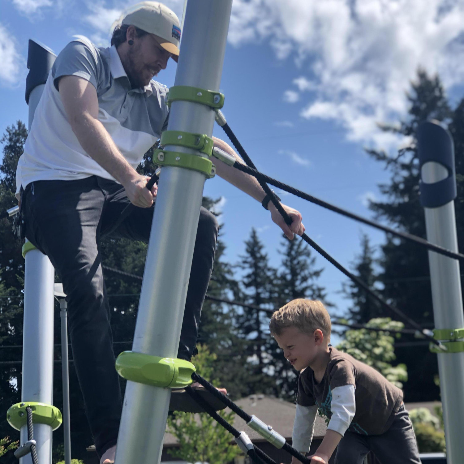 Aragon and Emily's little brother Ansel seeing who can climb higher at the local park.