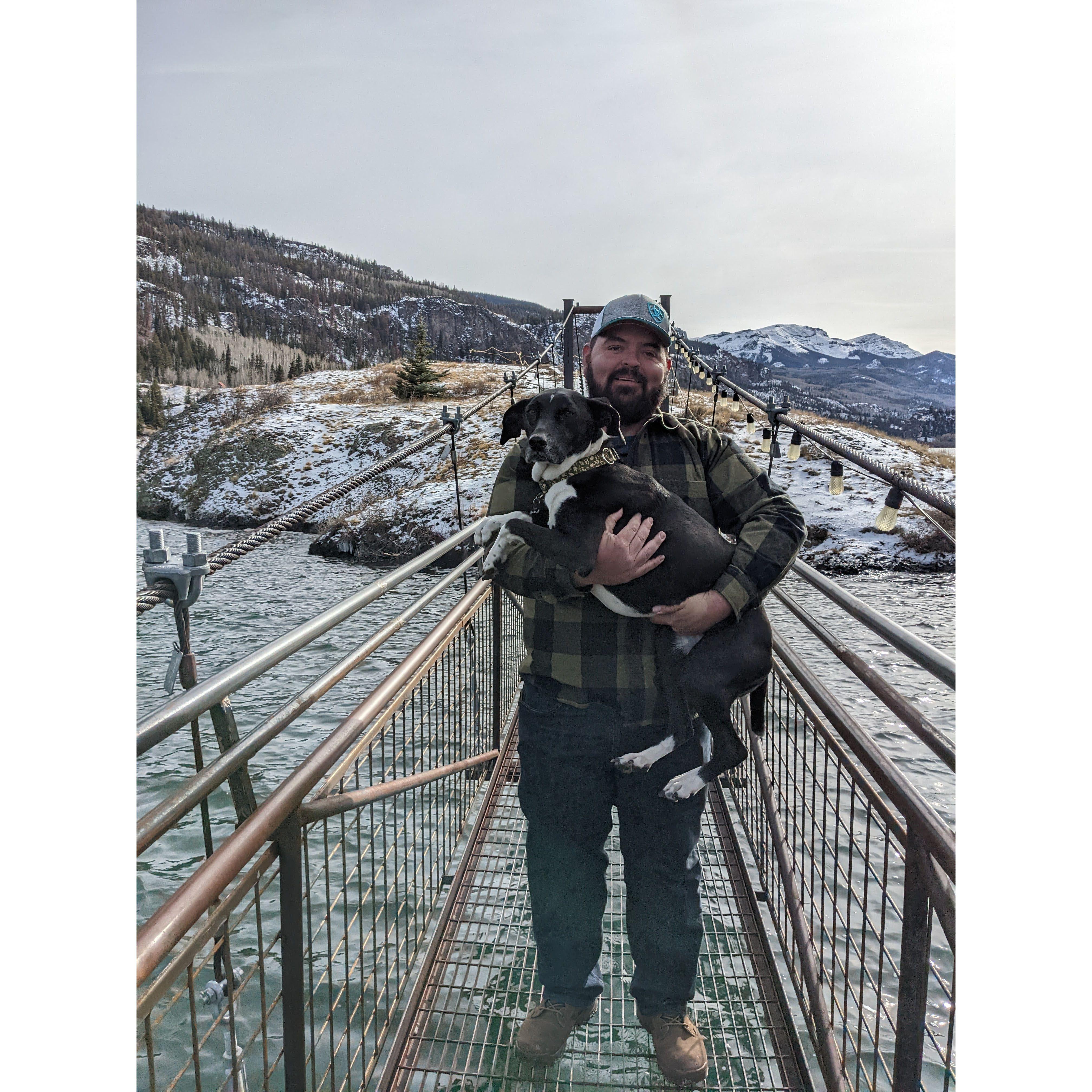 The faithful man carrying the scaredy cat dog
