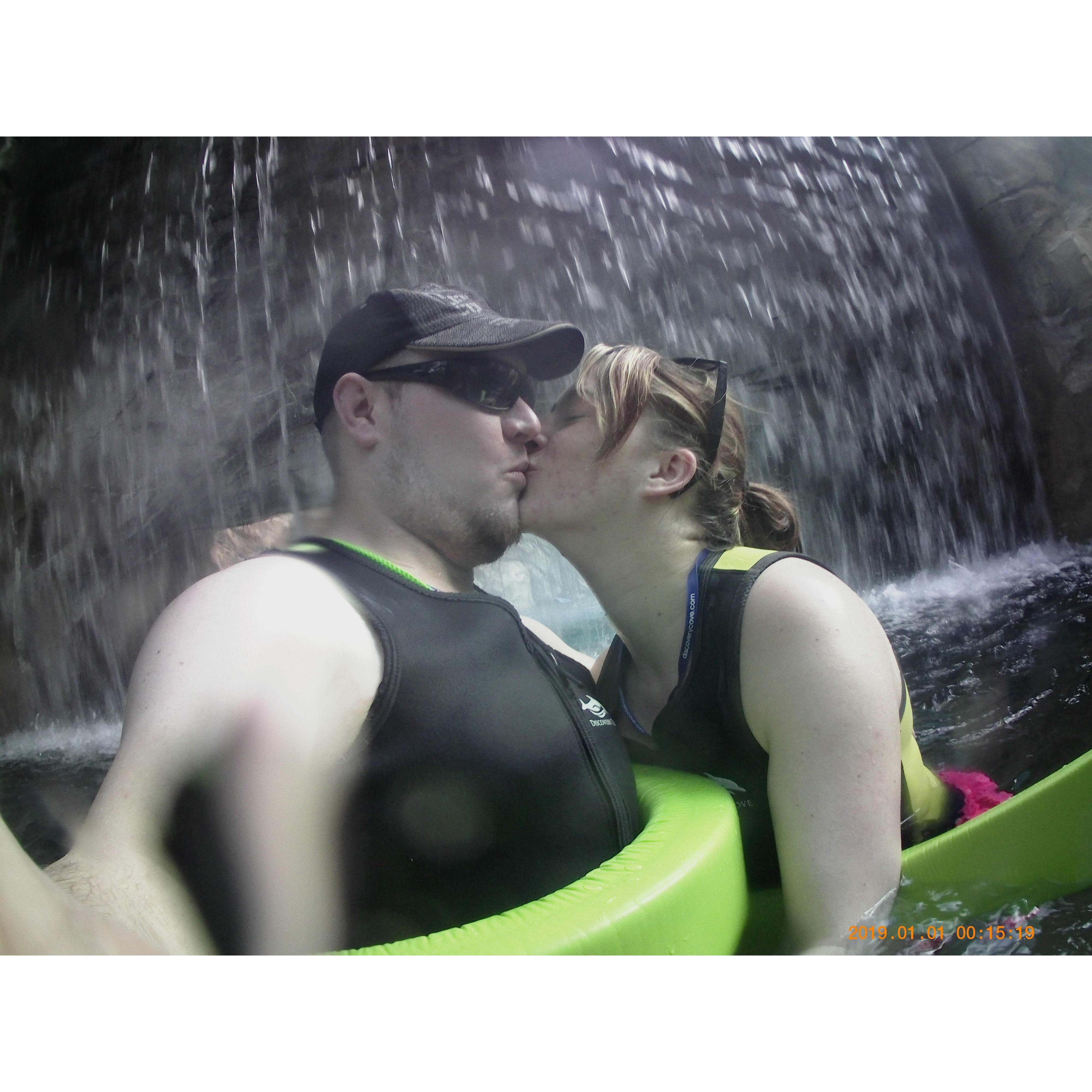 A romantic kiss under the waterfall