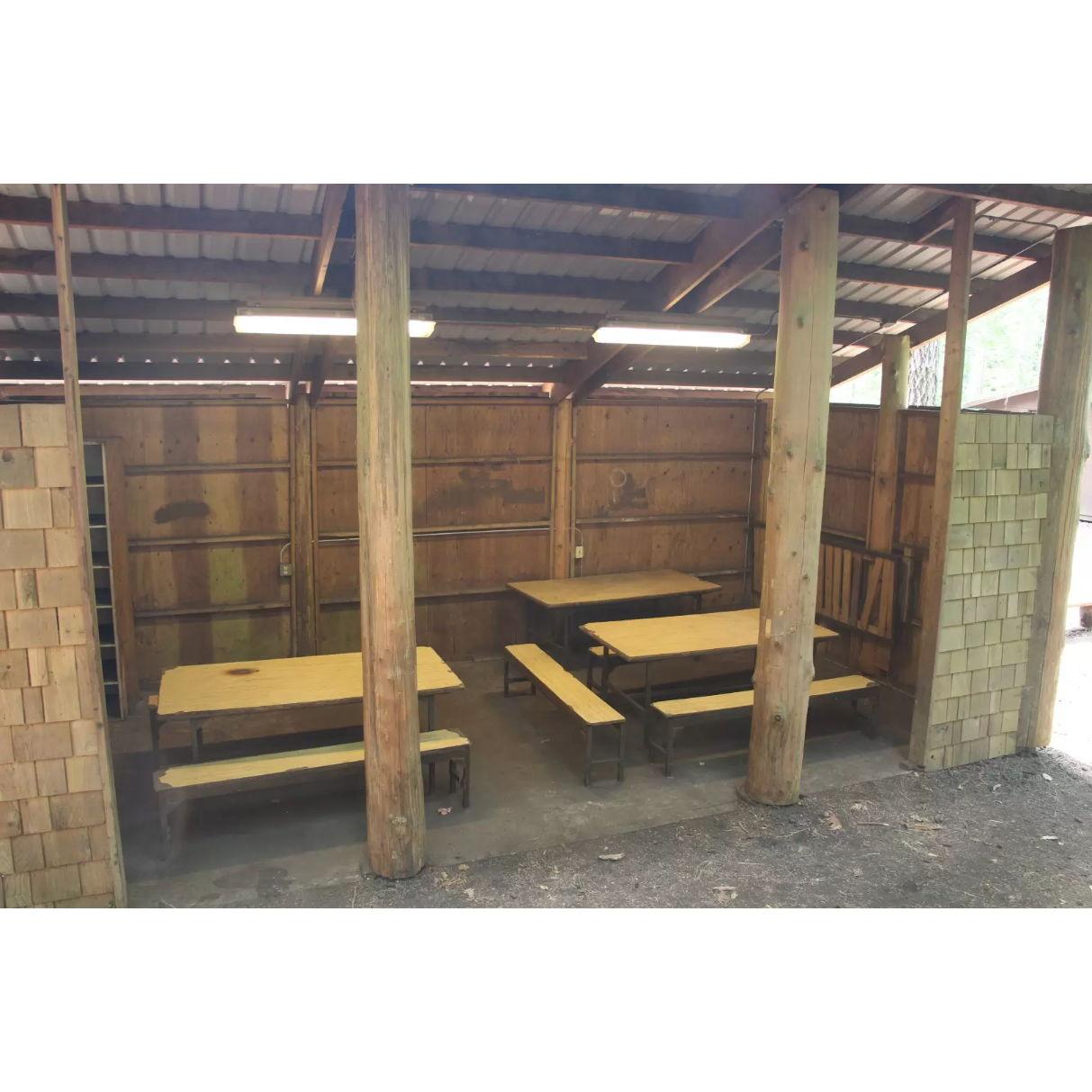 Powered and covered seating/cooking area nearby the cabins
