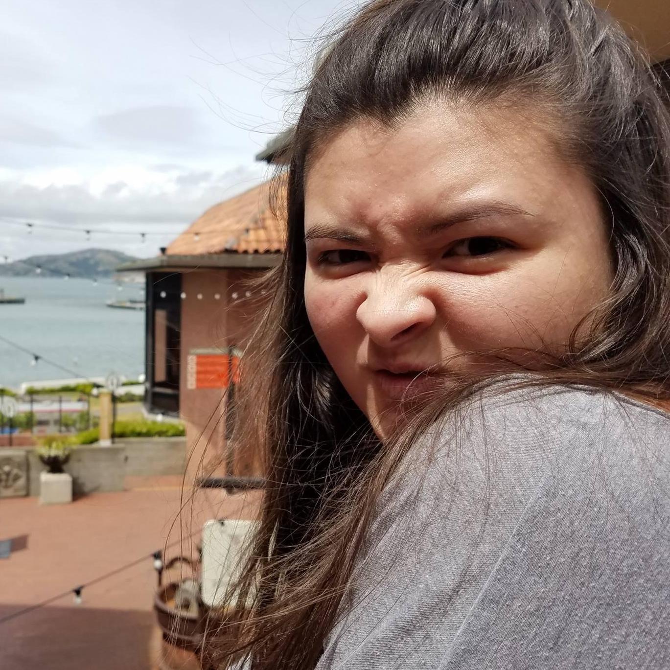 Making the mean smirk face inside Ghirardelli Square.