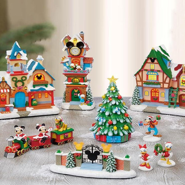 MOMENTS IN TIME Disney Christmas Village Collection 13 Pieces with LED Lights, Music & Timer Hand Painted Buildings and Cartoon Characters Battery Operated Holiday Decoration