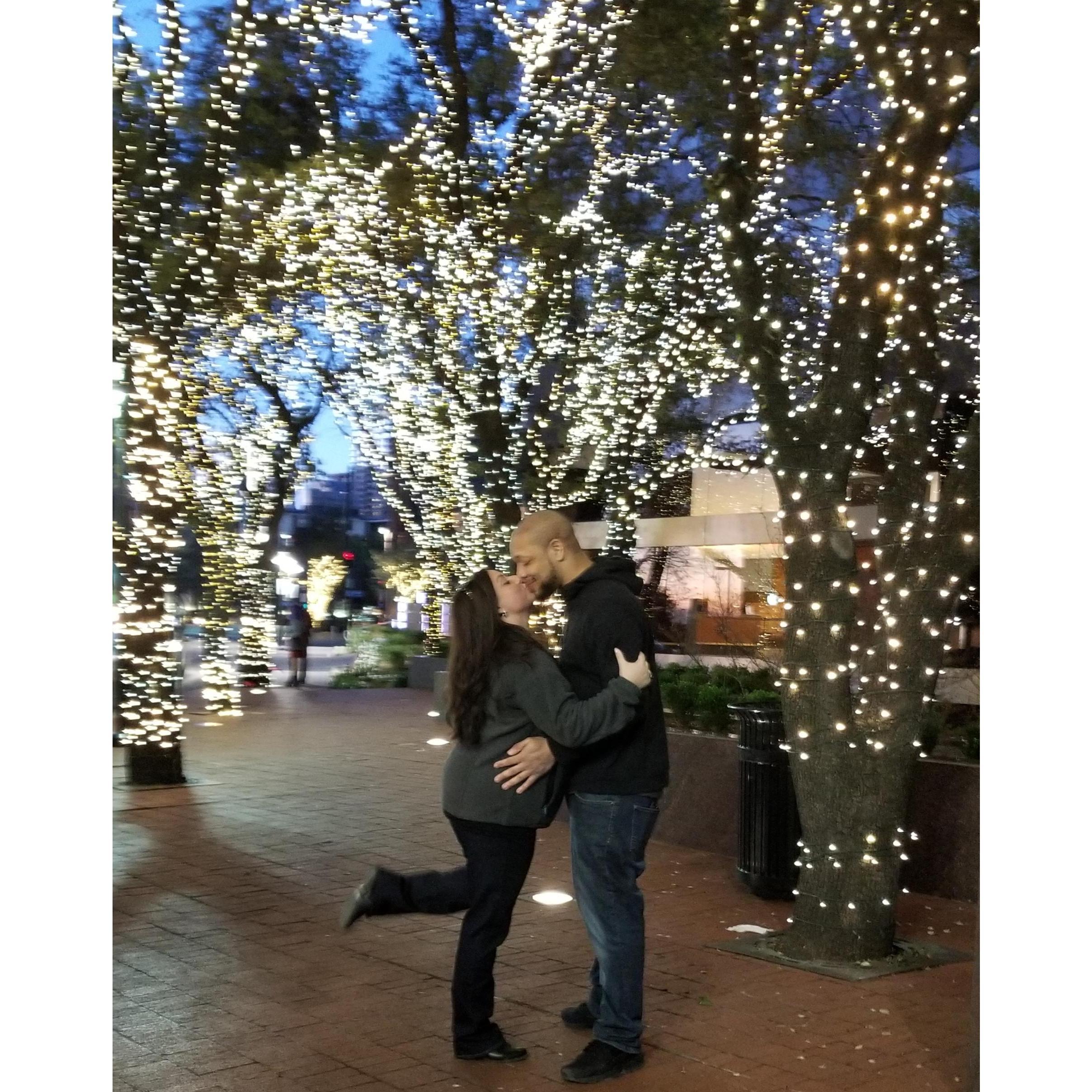 Kissing in the mist of the lights and summer night sky!