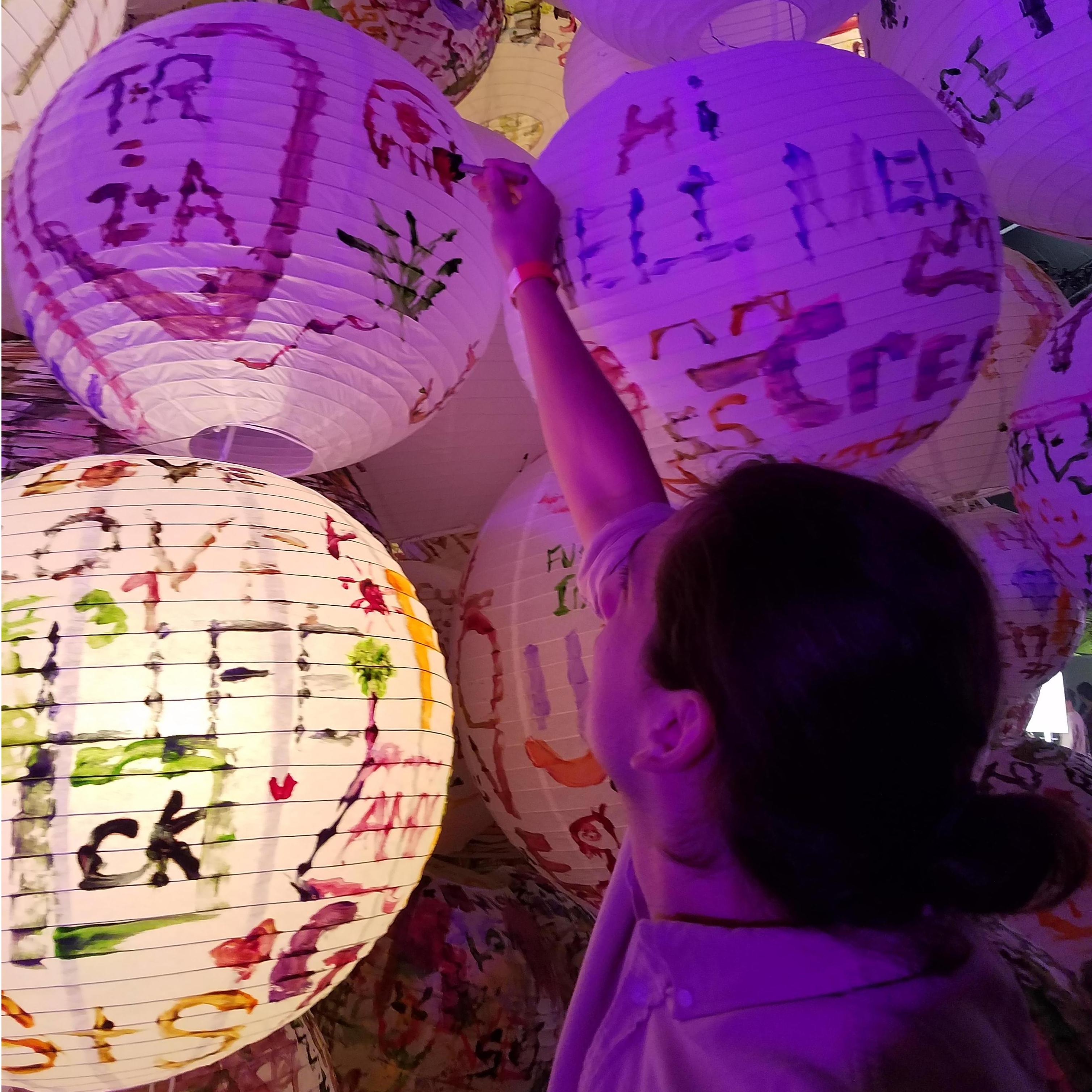 Ernest painting a lantern at a live art exhibit in LA