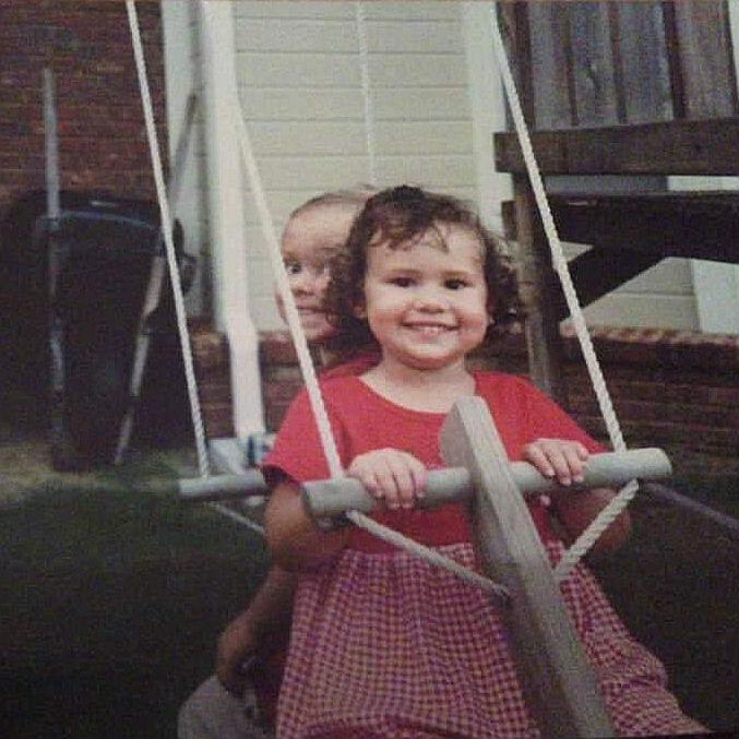 Cassidy and her older brother Brady on a swing.