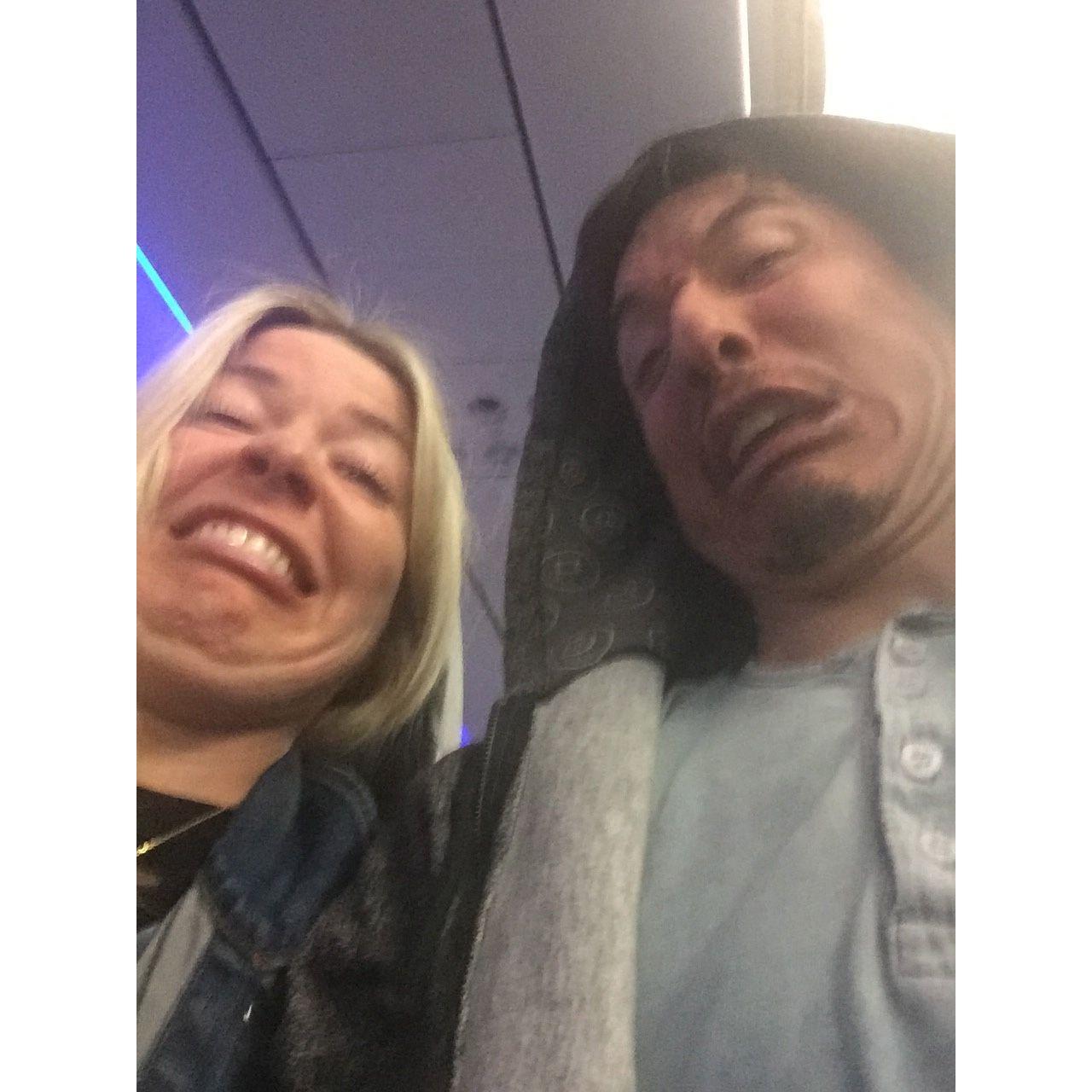 Alex and Jason liberate their face on their first flight together as a couple (to CA for Chloe and Bleu's wedding).