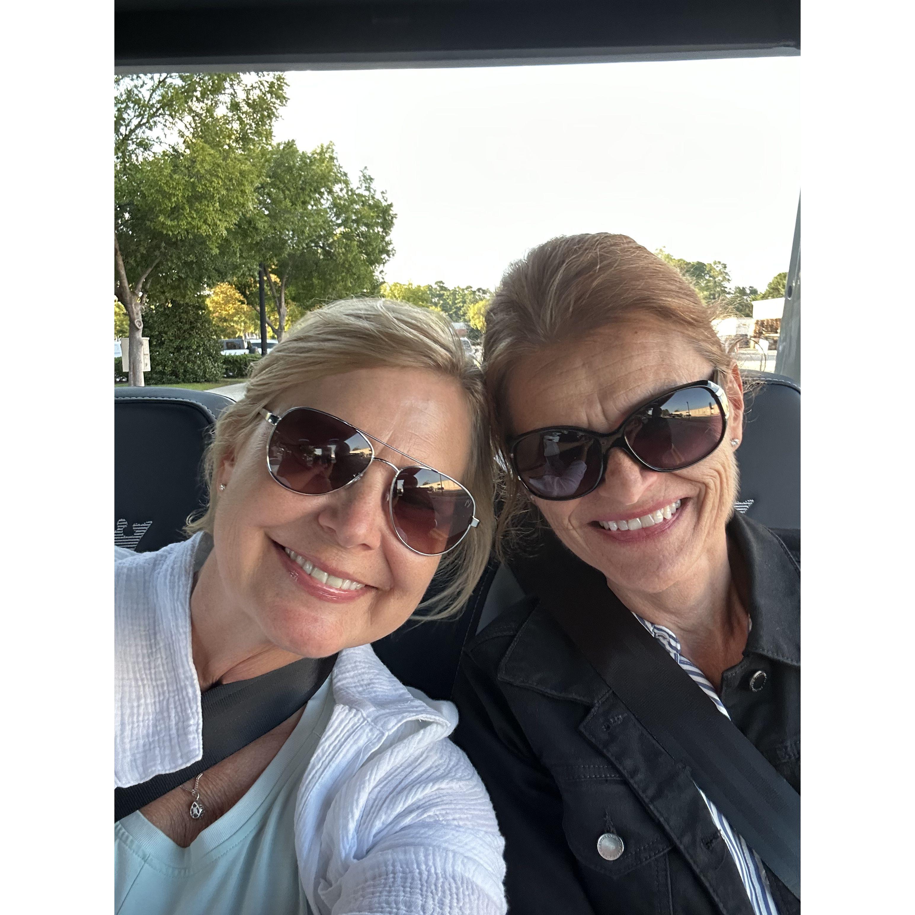 Barb and Chris take a back seat in the golf cart!
