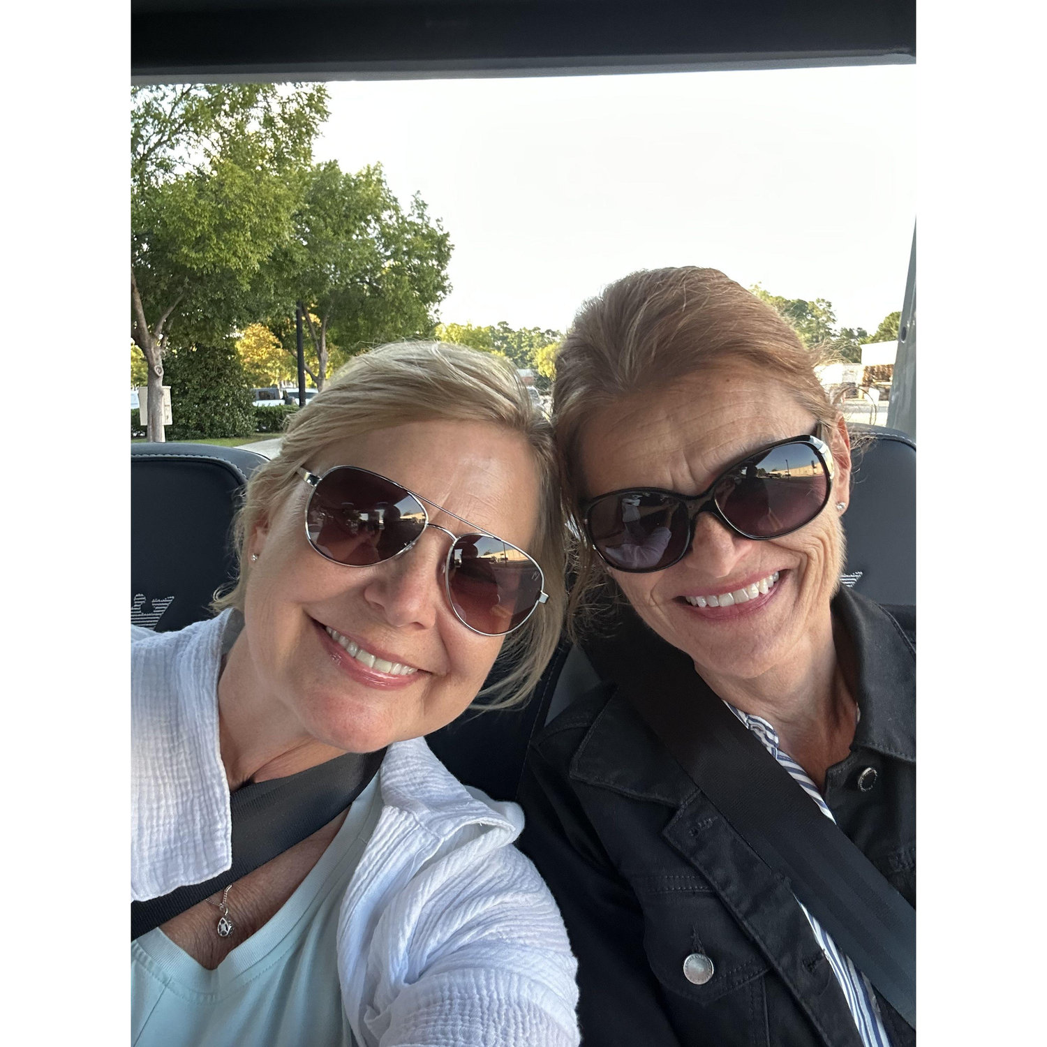 Barb and Chris take a back seat in the golf cart!