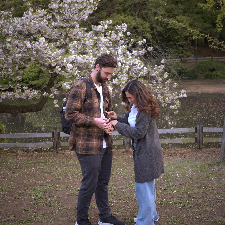 Placing the ring on Alyssa's hand
