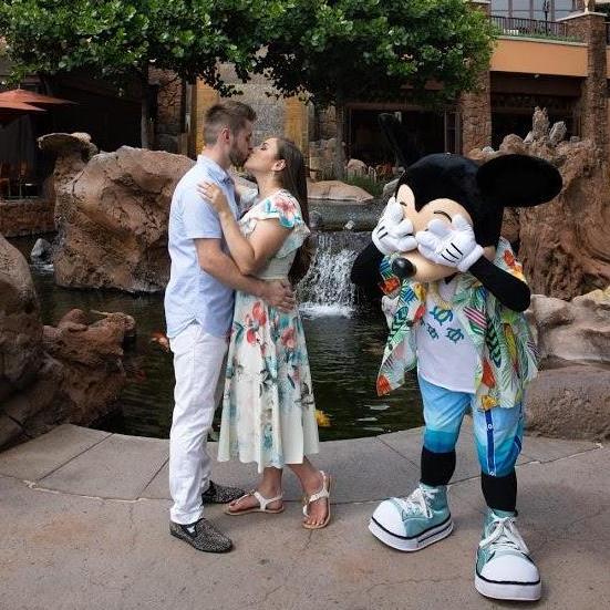 Sneaking a kiss. (Sorry, Mickey)