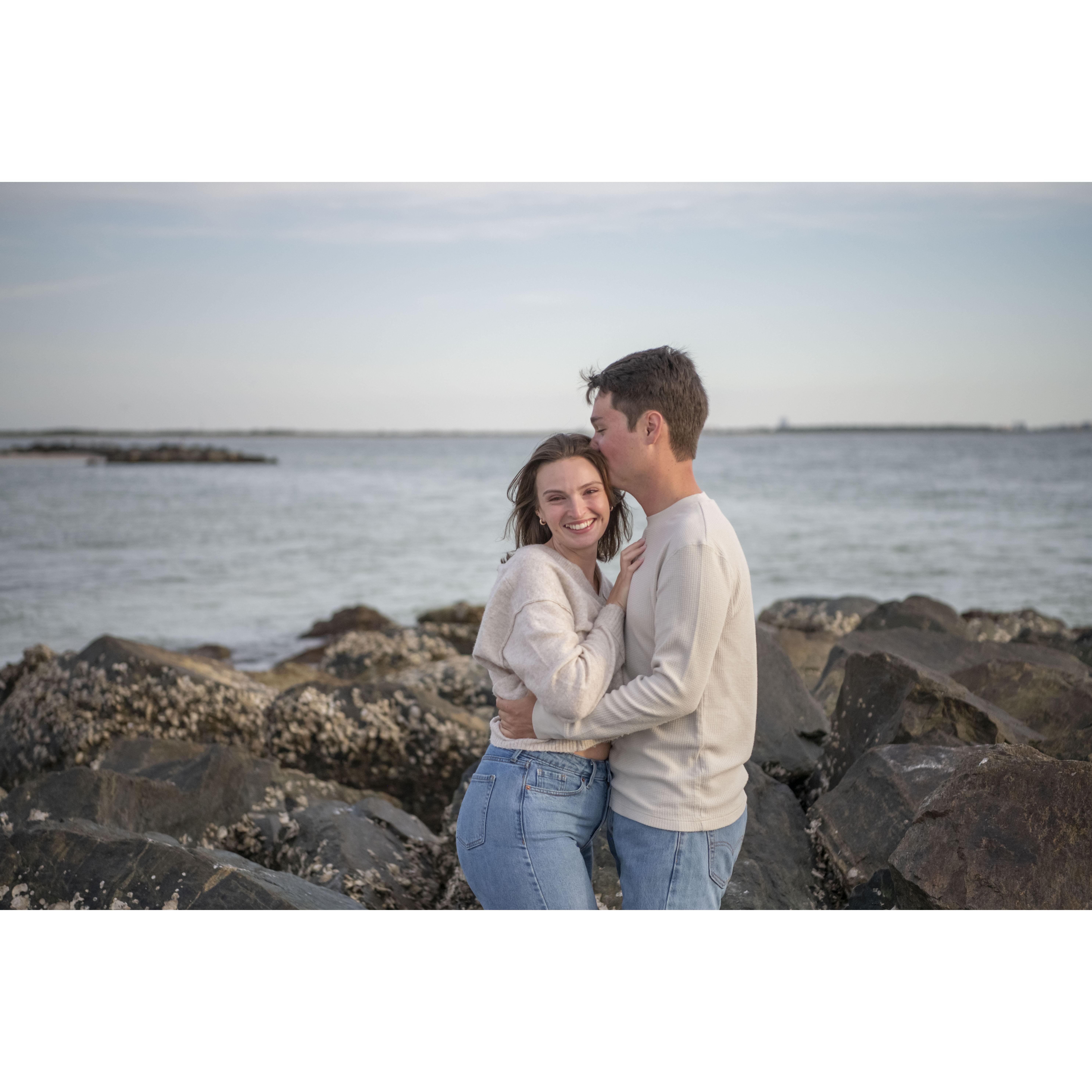 We were desperately avoiding barnacles on the jetty rocks for this cute pic