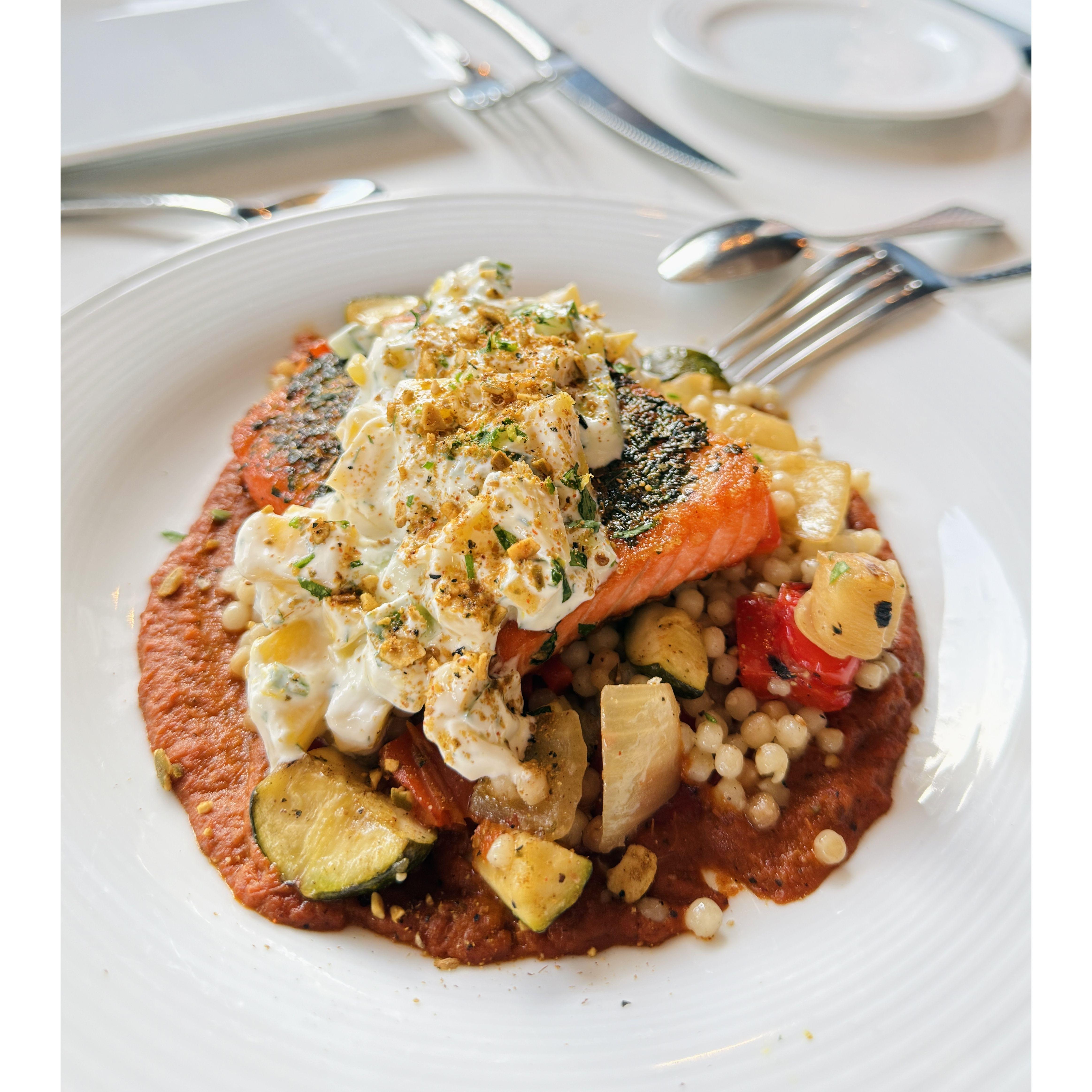 Herb-Seared Atlantic Salmon: Tender and flavorful with a mild, spicy kick from the harissa sauce.