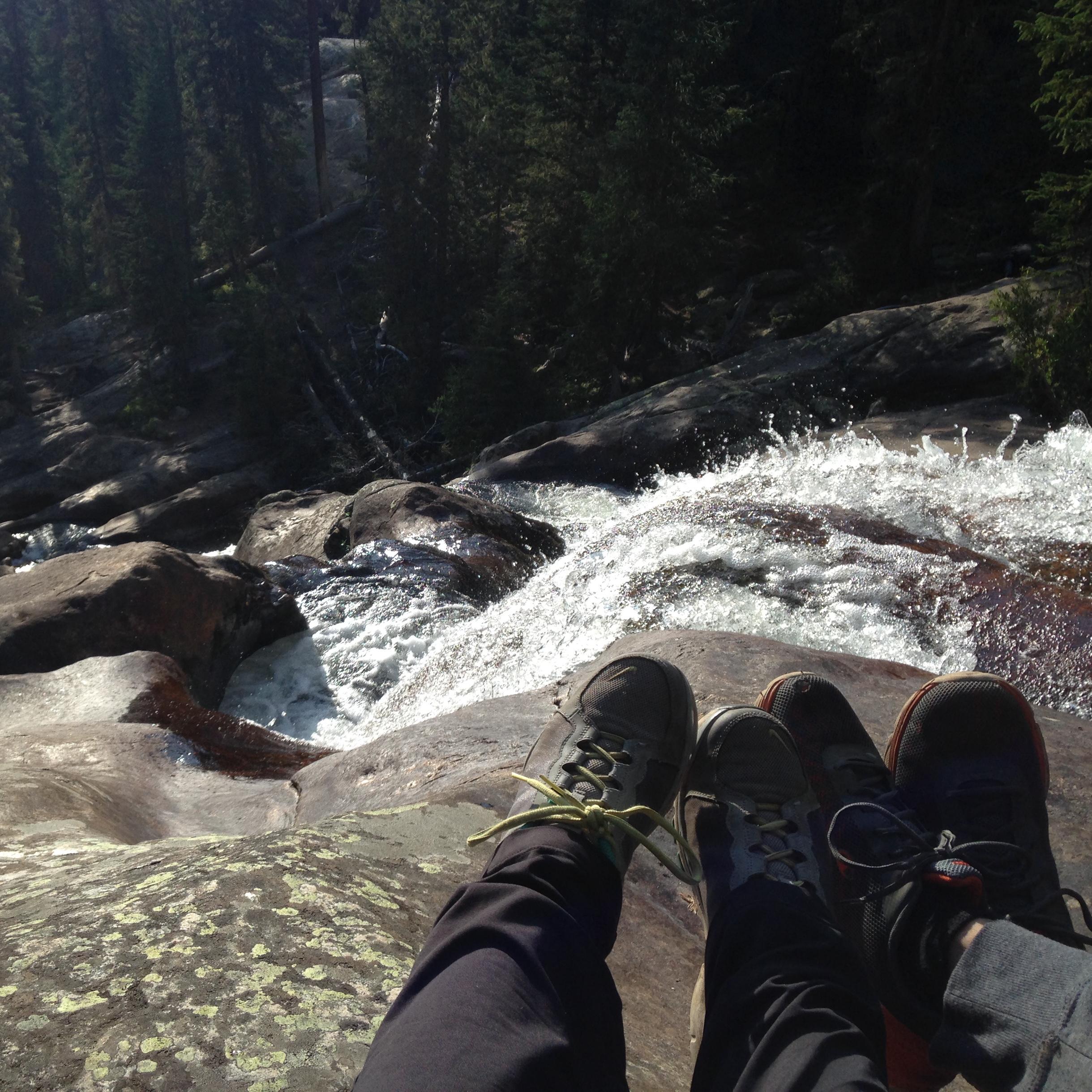 Our feet hanging off a waterfall in the Colorado Rockies (2016)