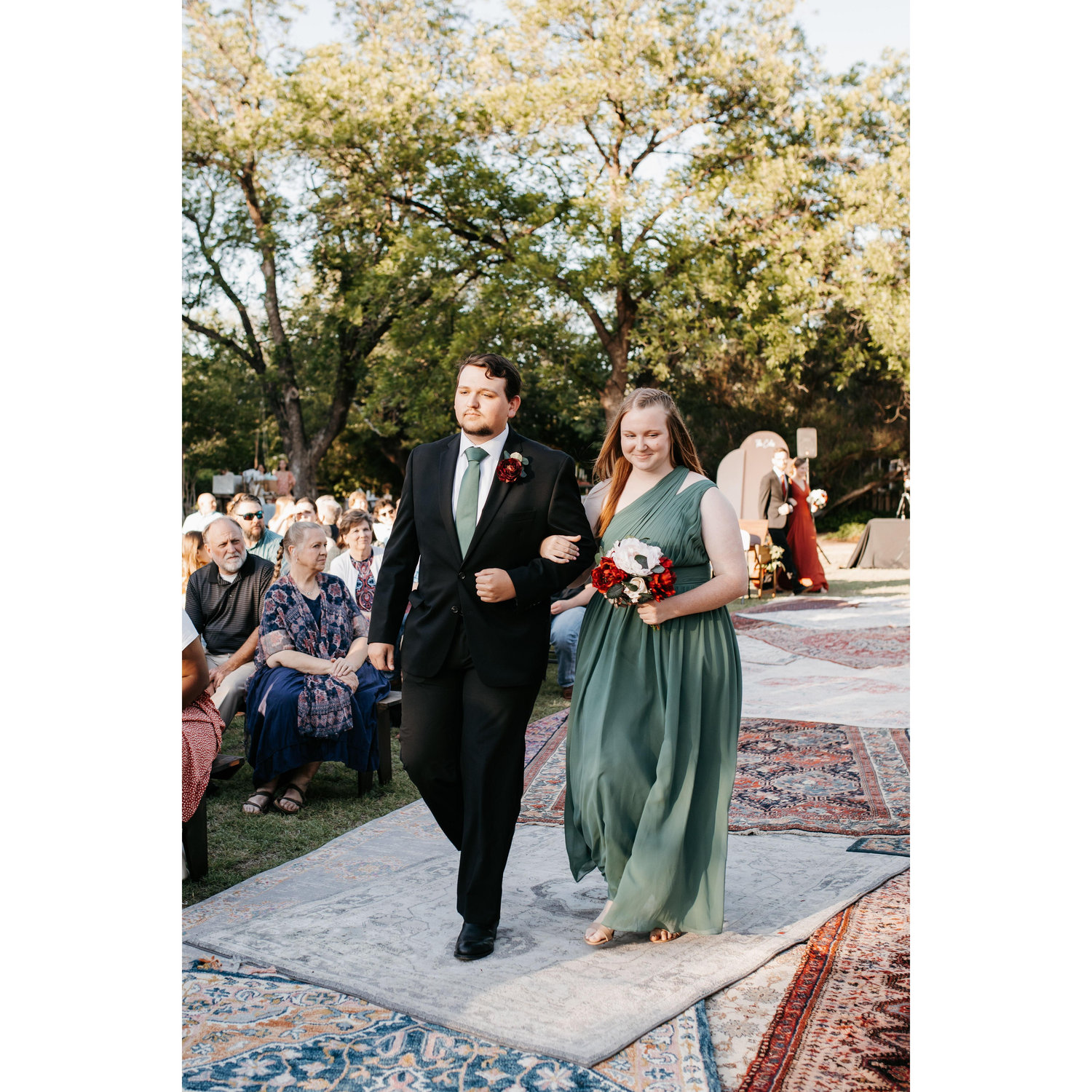 Literally where it all began... walking down the aisle together at Lauren and Logan's wedding in June 2022.