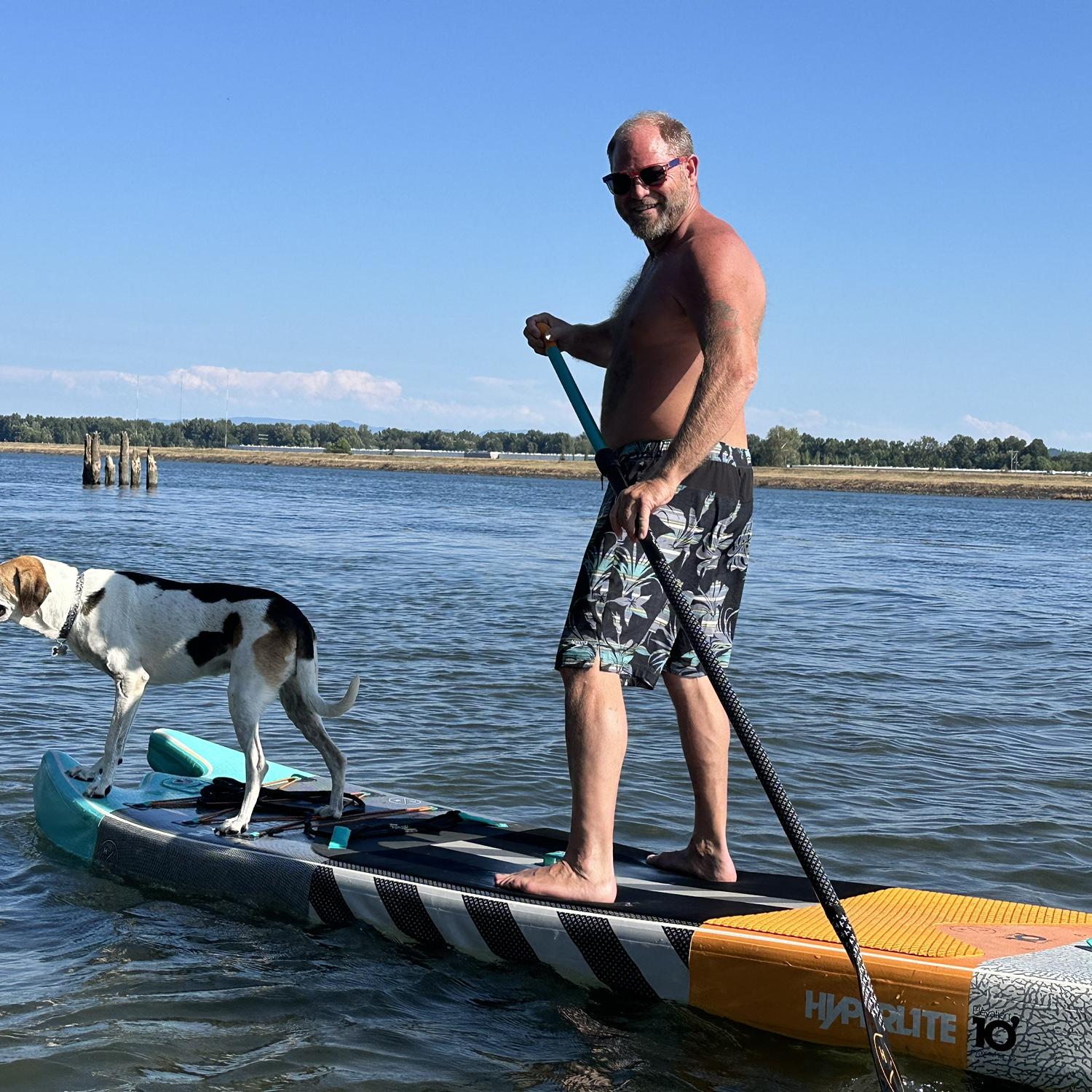 Paddle boarding with Penny on the river, August 2024.