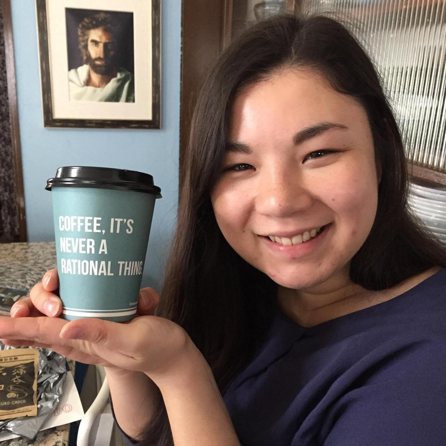 Lisa and her coffee... with Jesus in the background.