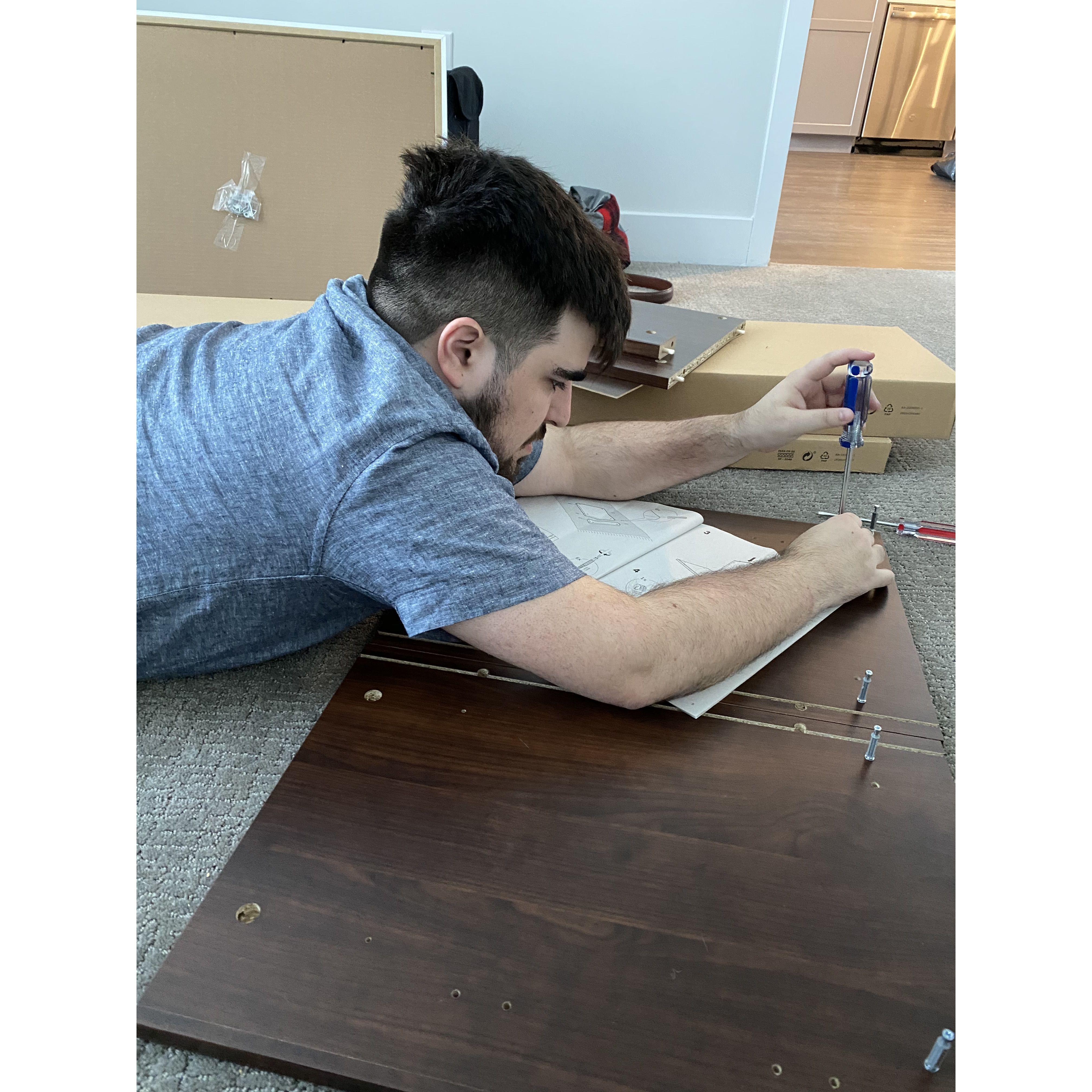 A picture of Joey very bravely putting together our IKEA furniture.