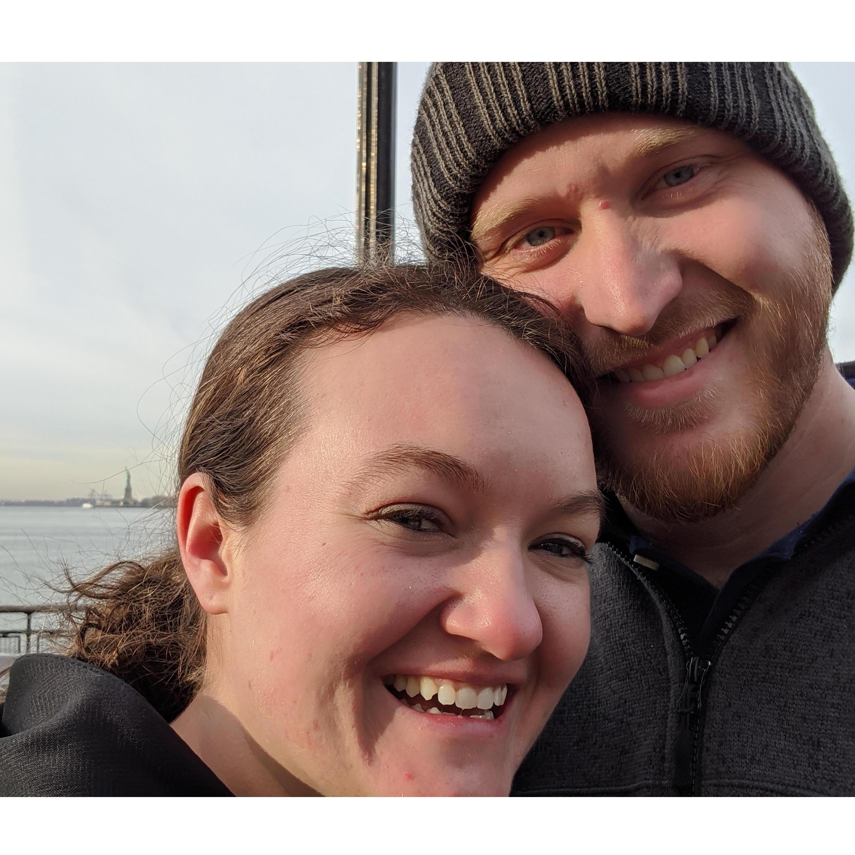 In front of the statue of liberty on our layover in NY, NY.