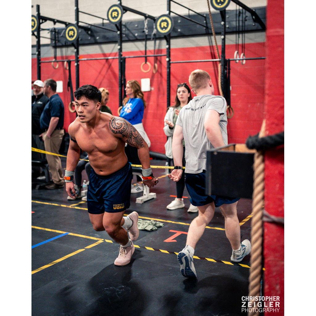 Mae cheering on Shaq at a Crossfit competition