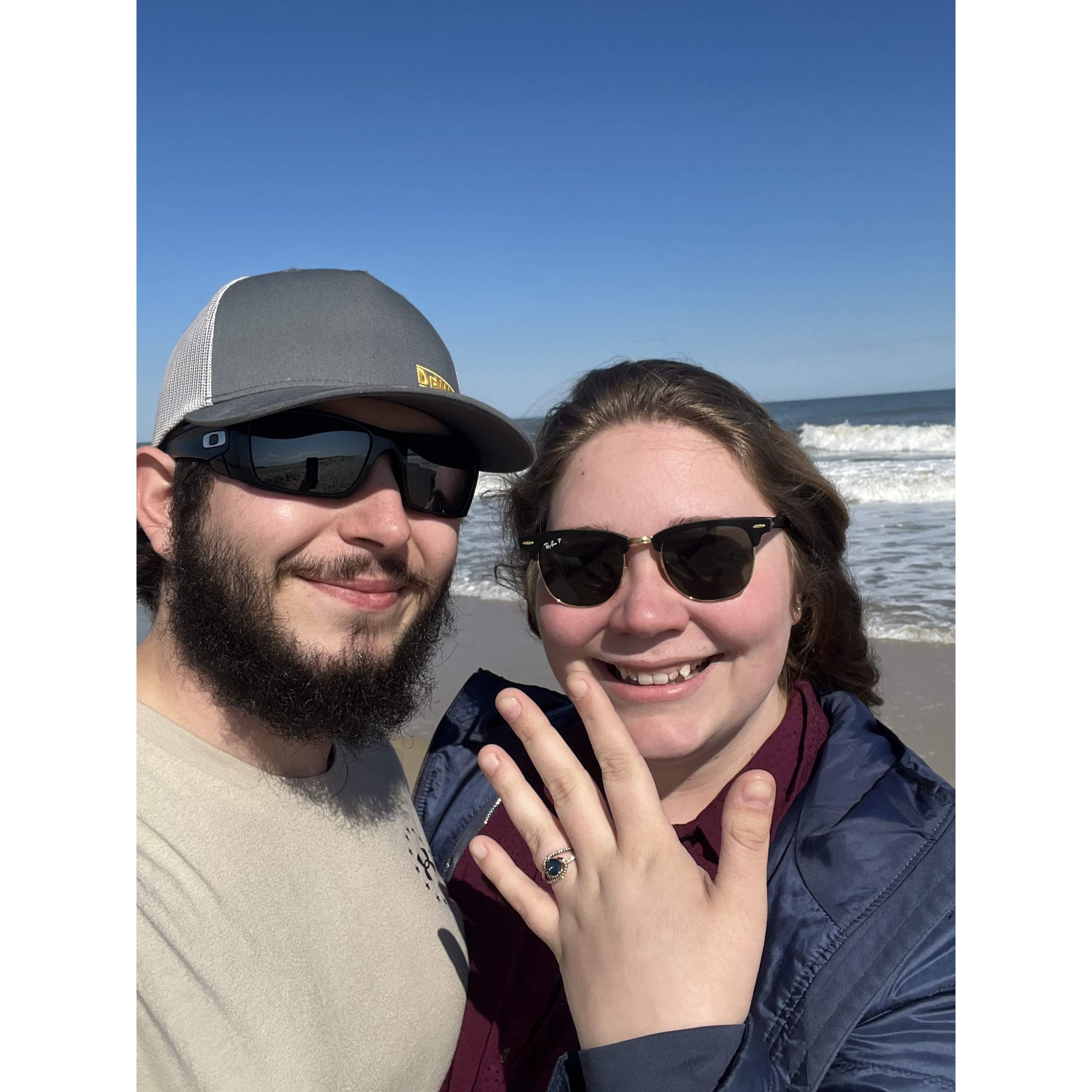 Us on the beach the day after we got engaged in 2022