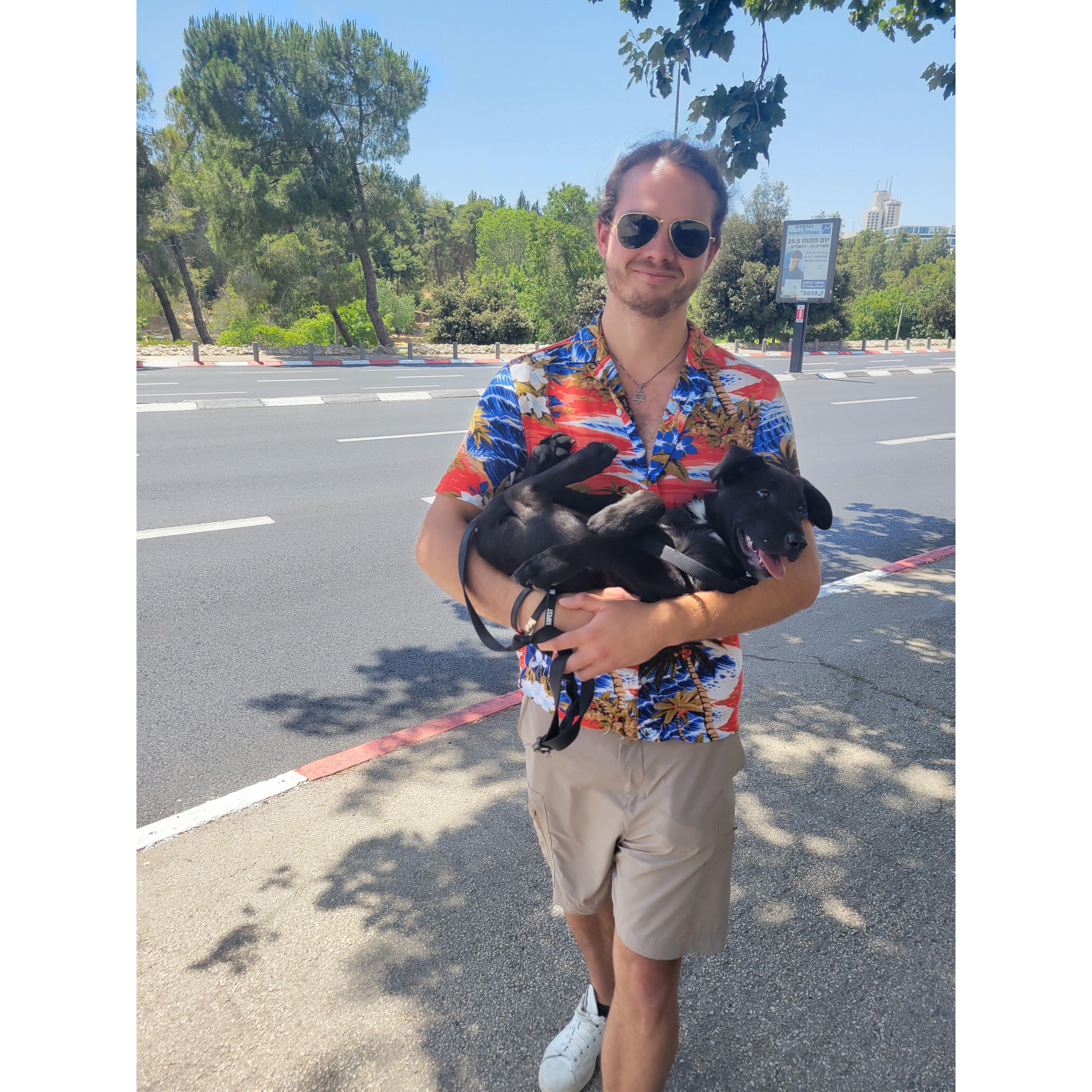 David carrying Hugo Home from the vet. Sofia is behind the camera thinking, "He's carrying a puppy, definitely a keeper".