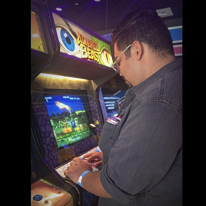 Emilio enjoying his game at the arcade.