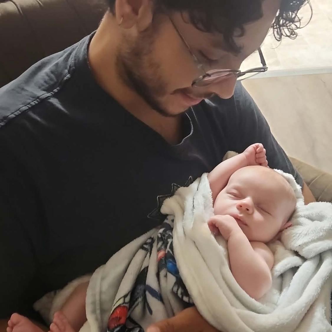Holding our god son for the first time 💙