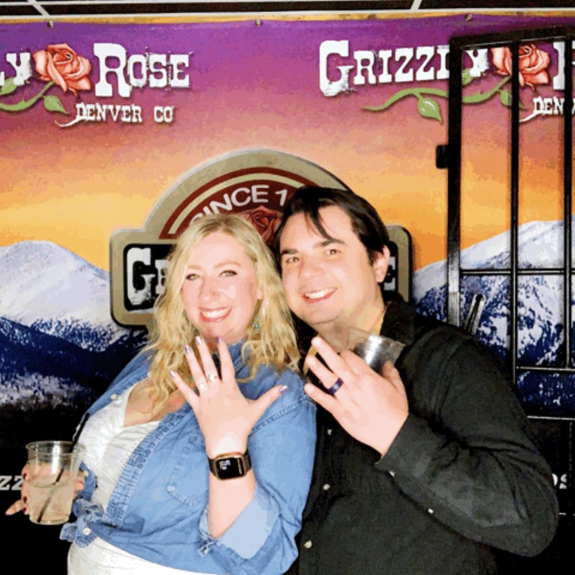 Proudly showing off our rings and Texas roots at a country bar