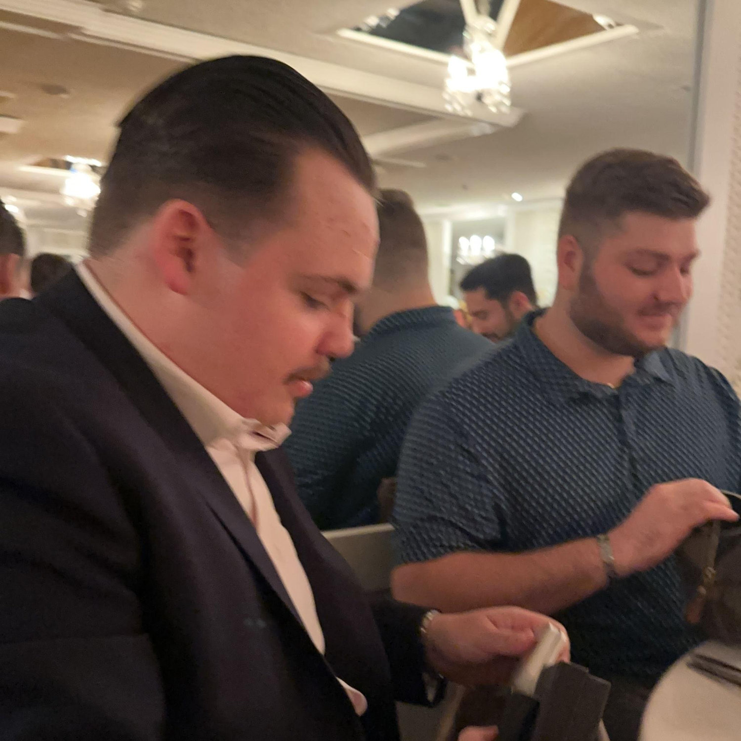 Groomsmen opening their Groomsmen gifts.
