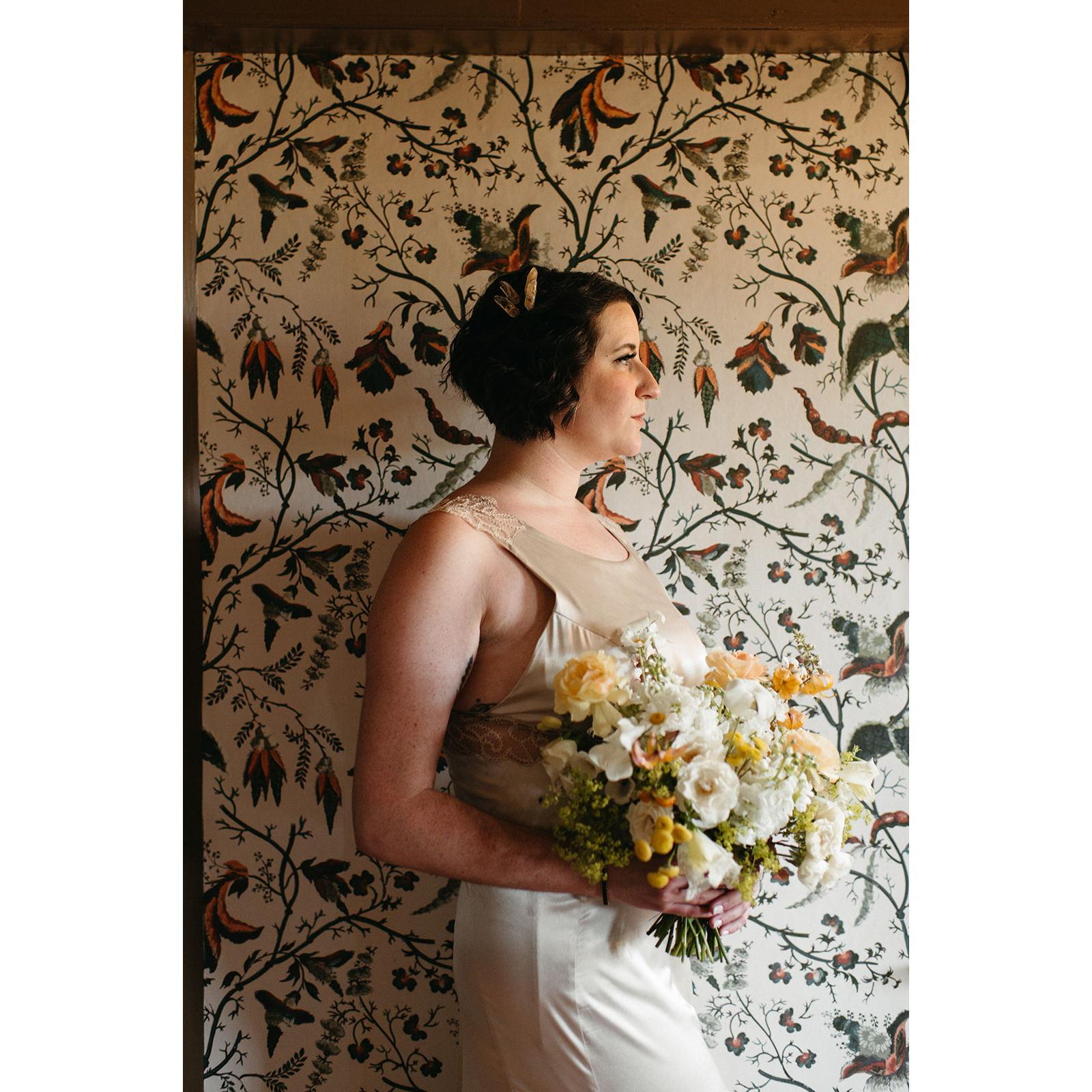 Rachel wore citrine pieces in her hair, a crystal that represents sunshine, light, and happiness, as well as success. Her bouquet was filled with gorgeous, locally sourced flowers by Helios Floral.