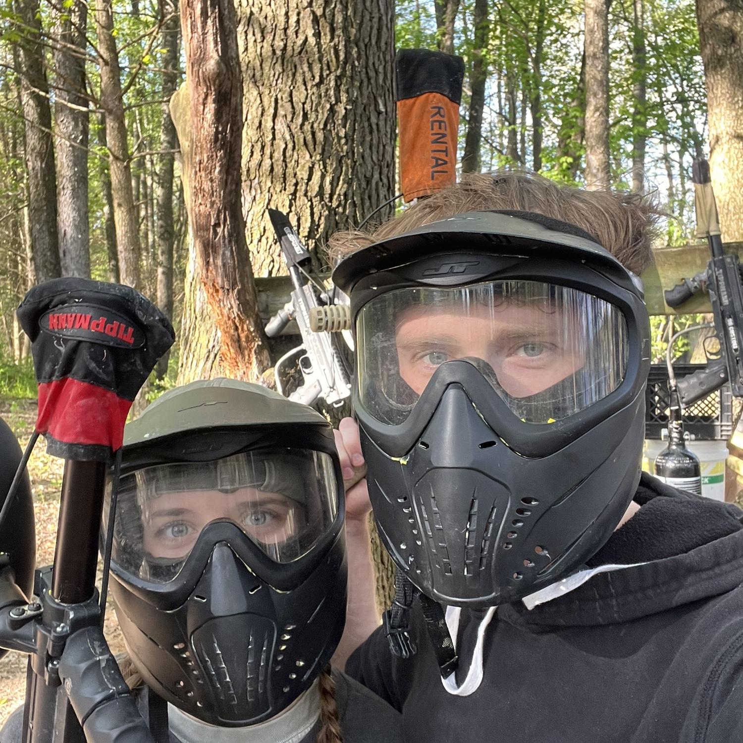 David helping Kendra with paintball out at camp