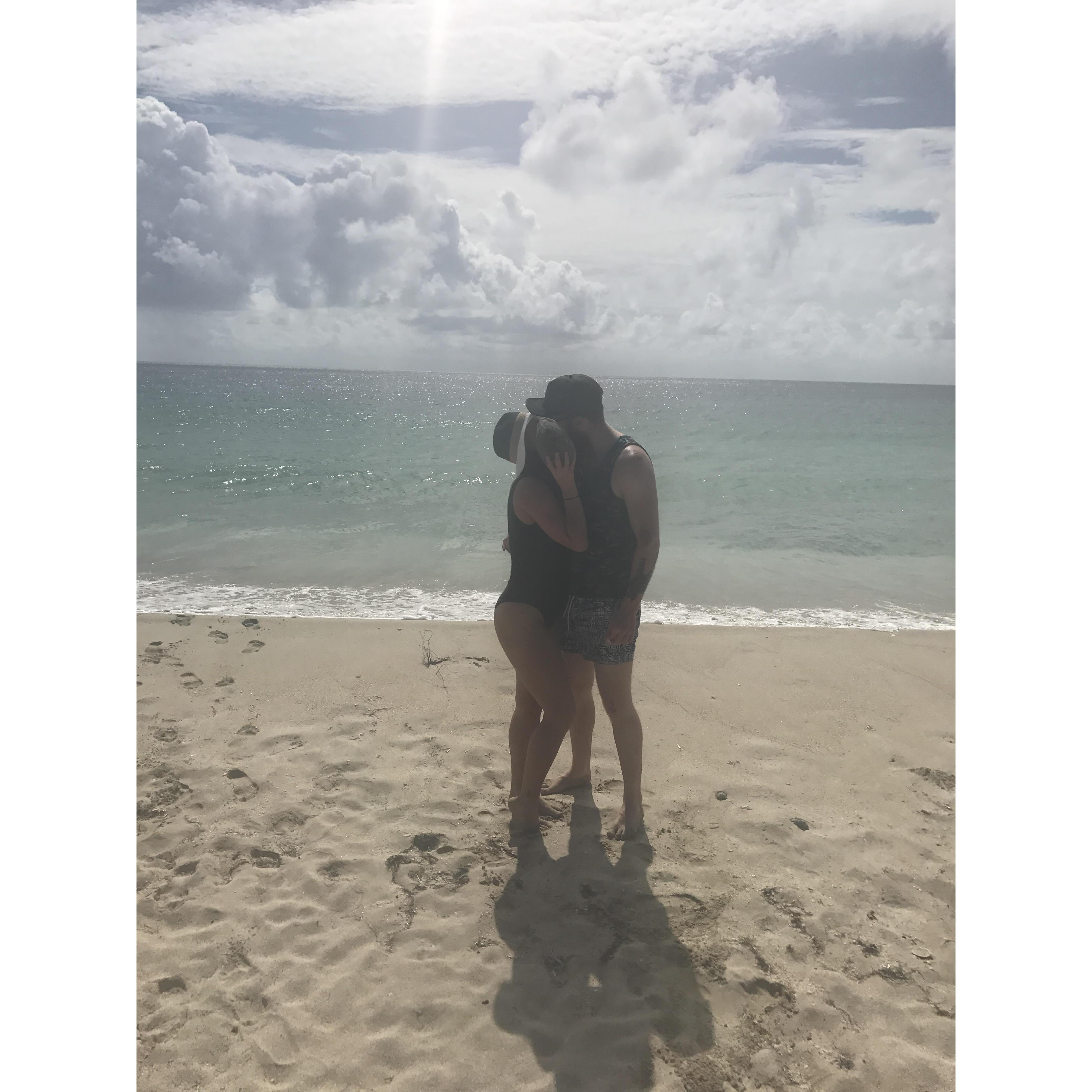 Kissing behind coconuts.