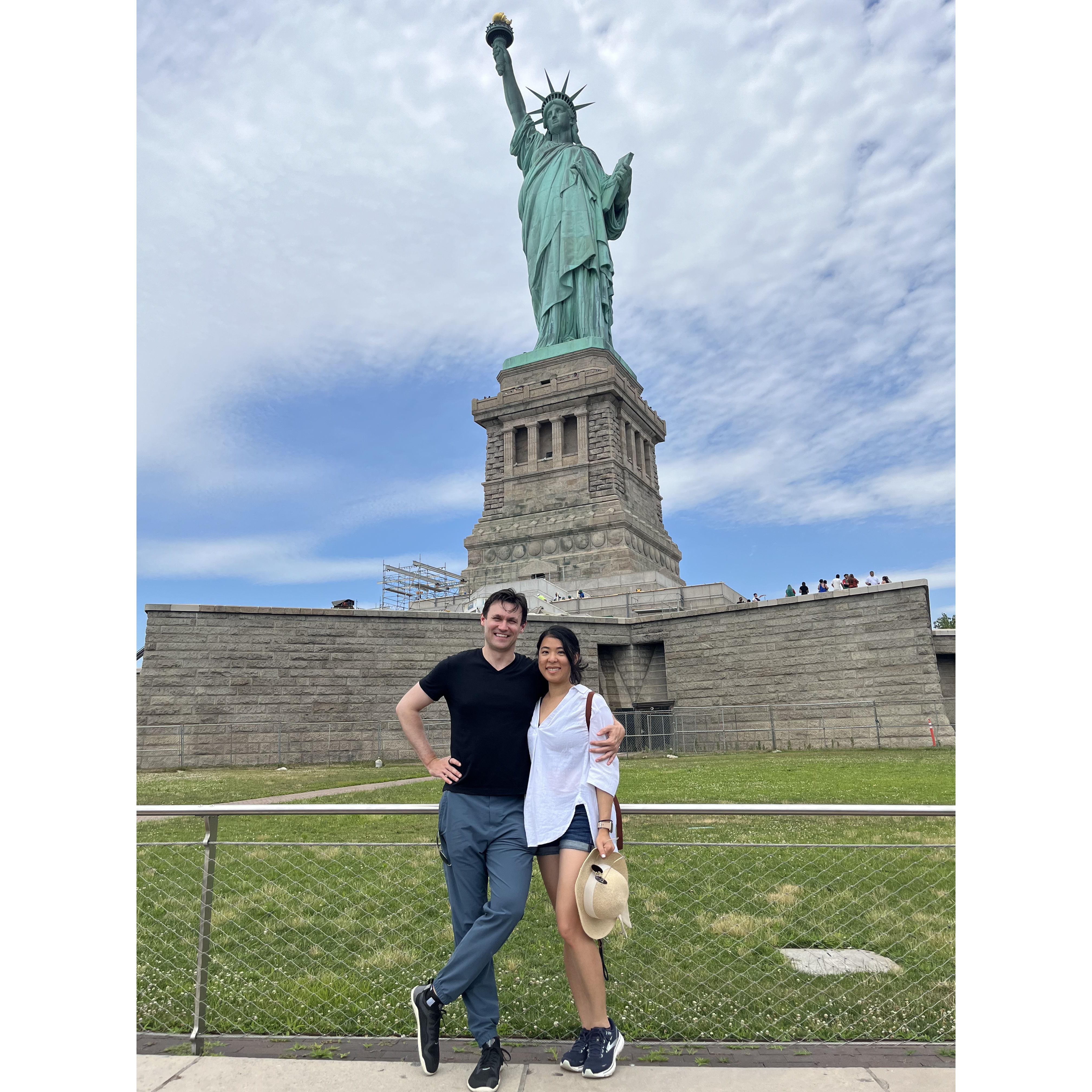 In front of the Statue of Liberty.