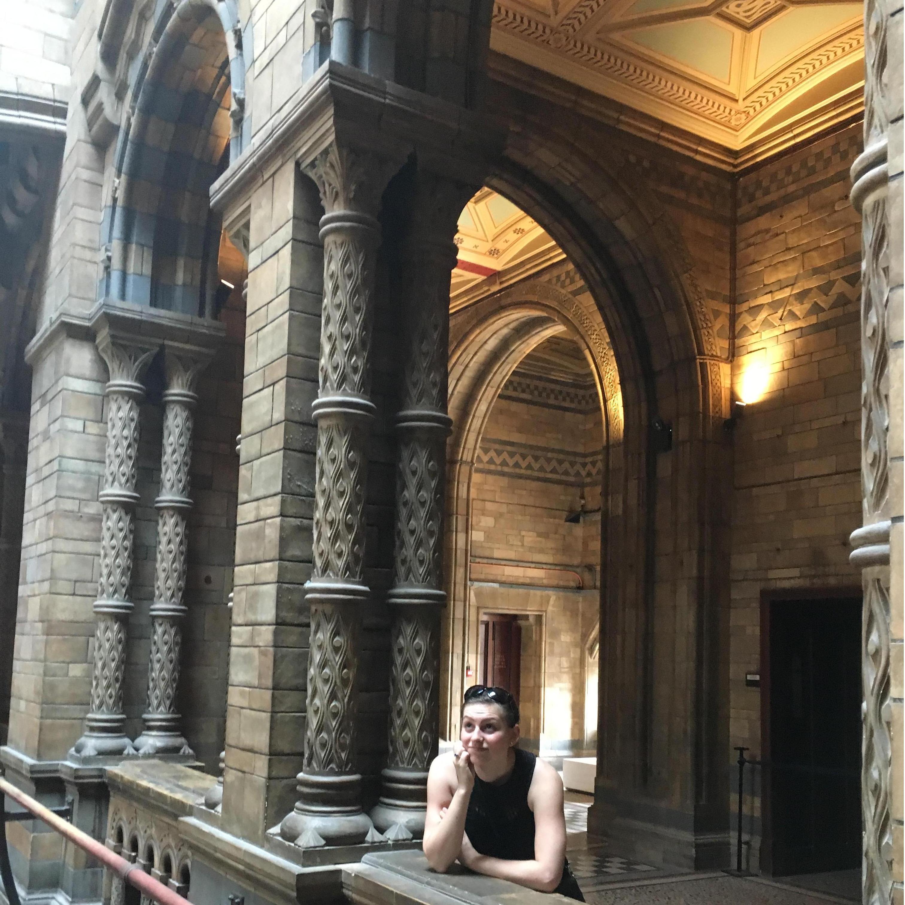Elizabeth under the arch. She had other great pictures from the museum, but this one captures the intricacy of the building design. Great lighting too. (07/2018, Museum of Natural History, London UK)