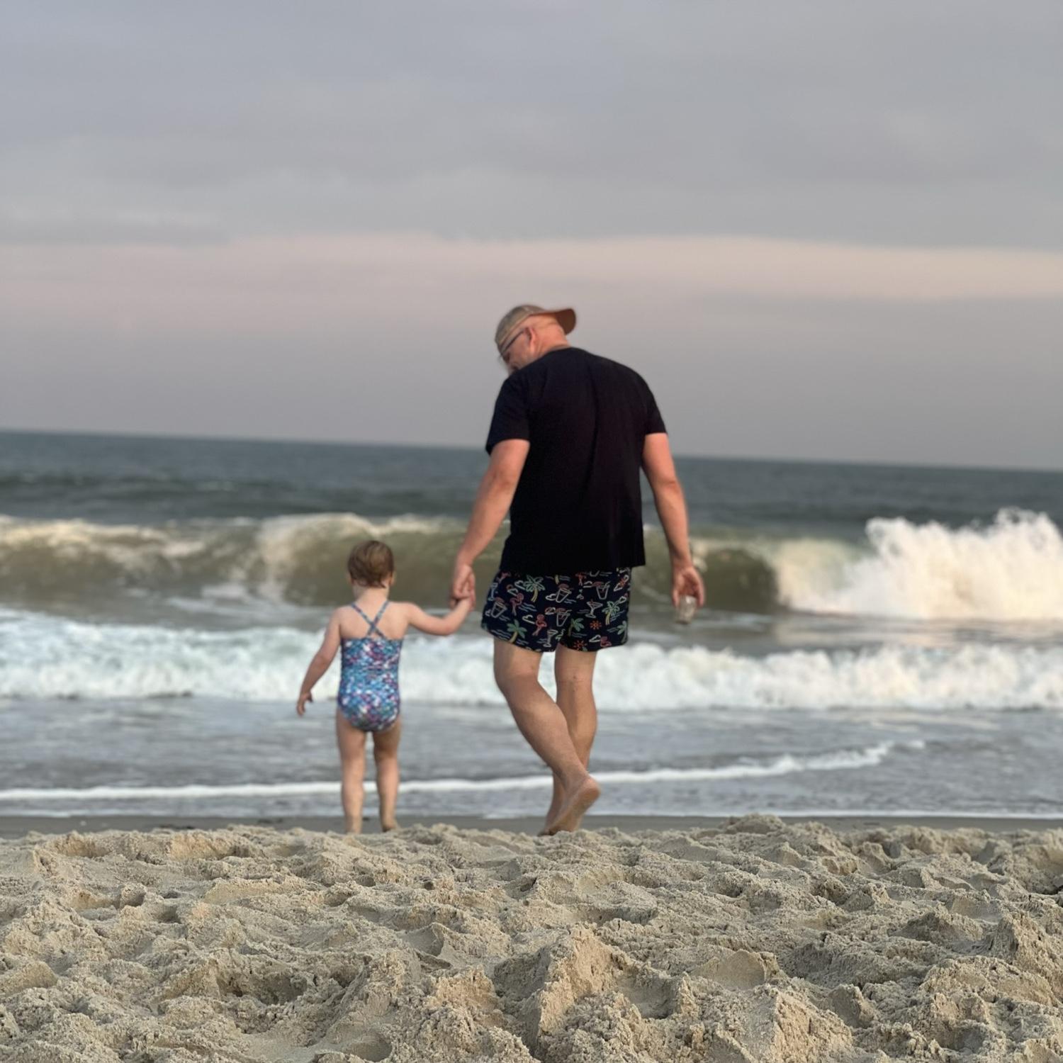 Uncle Rob and Marlowe walk on the beach