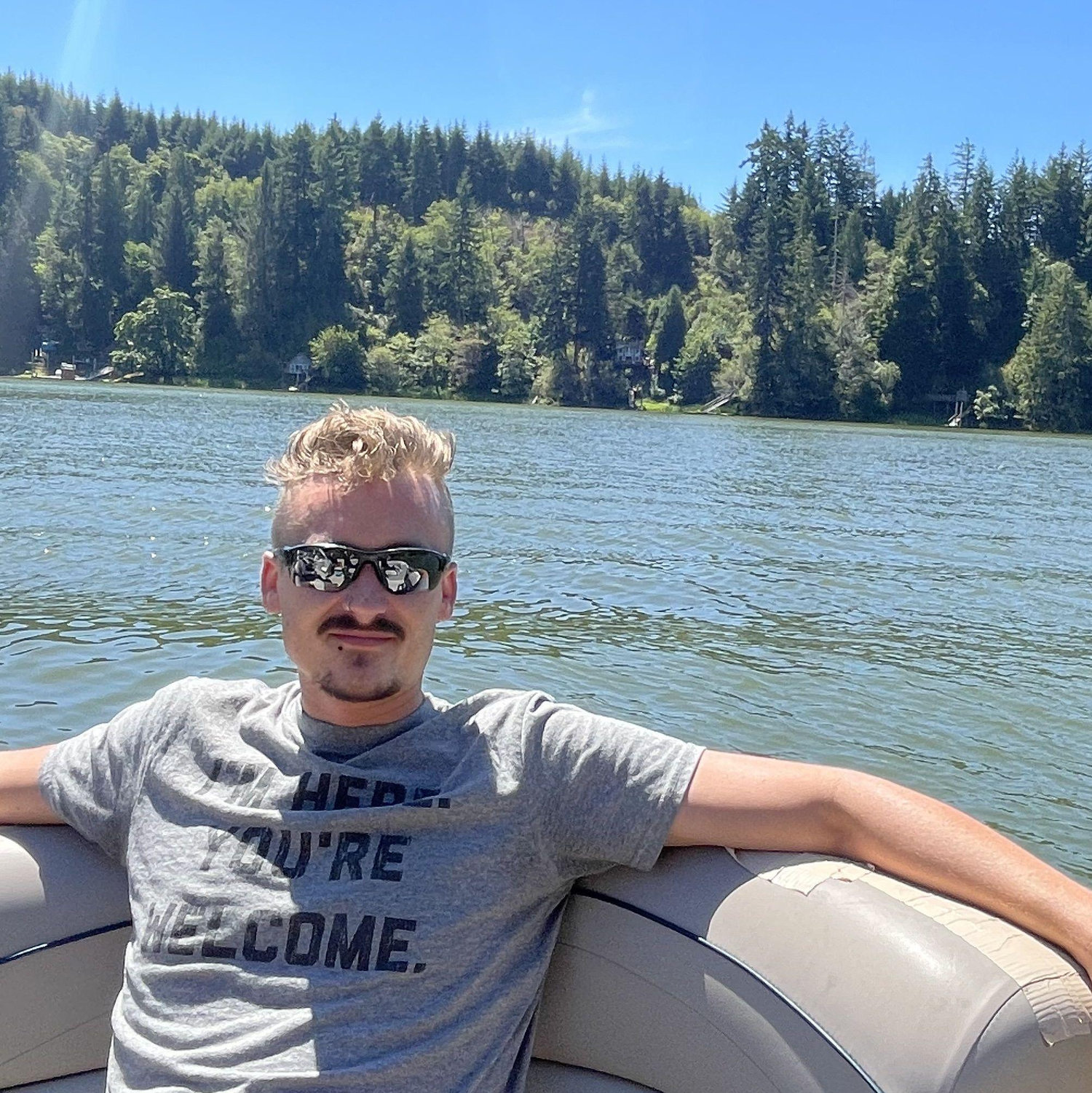 Kyle relaxing on Grandpa Toy's boat on Tenmile Lake in OR, August 2025.