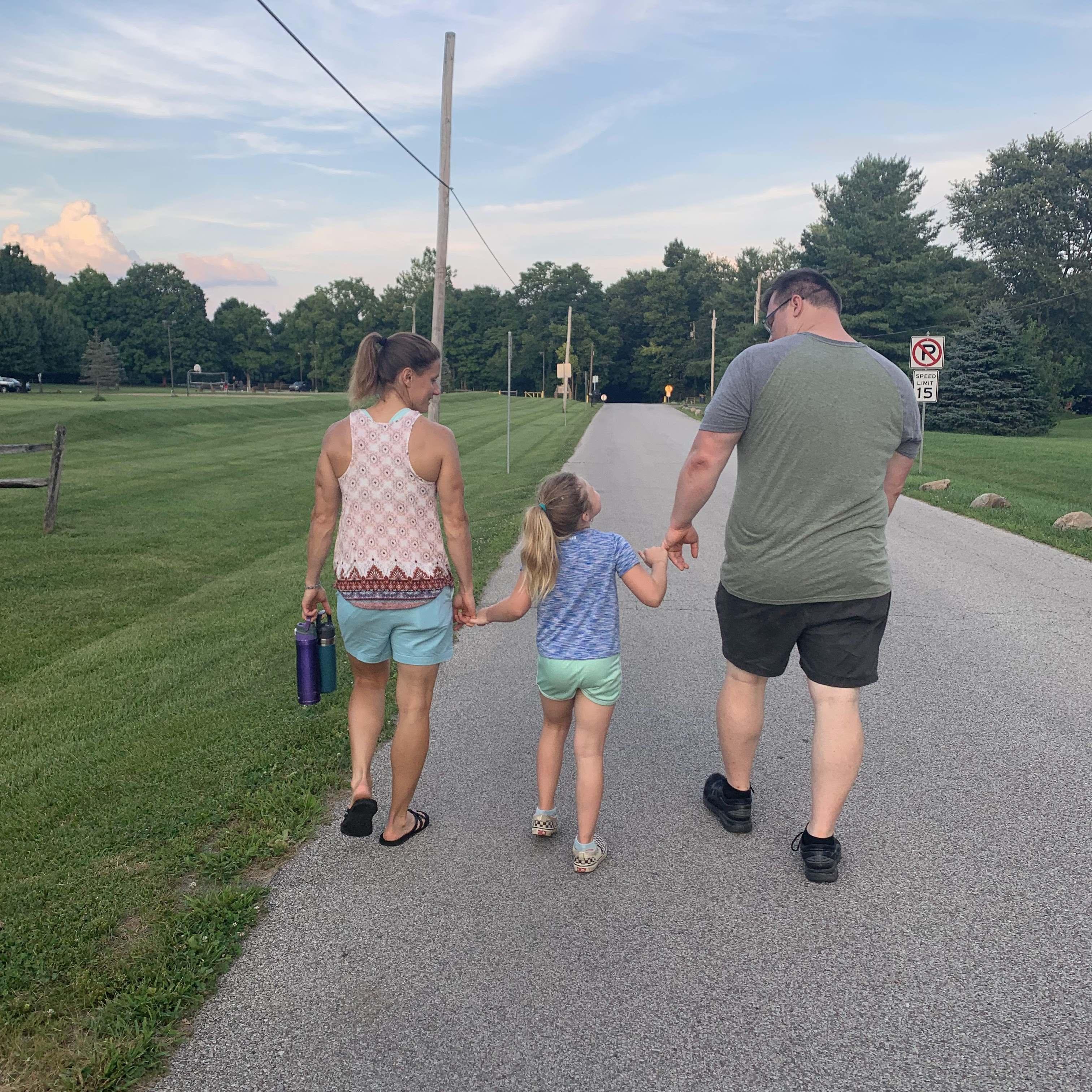 Holding hands on a family walk.